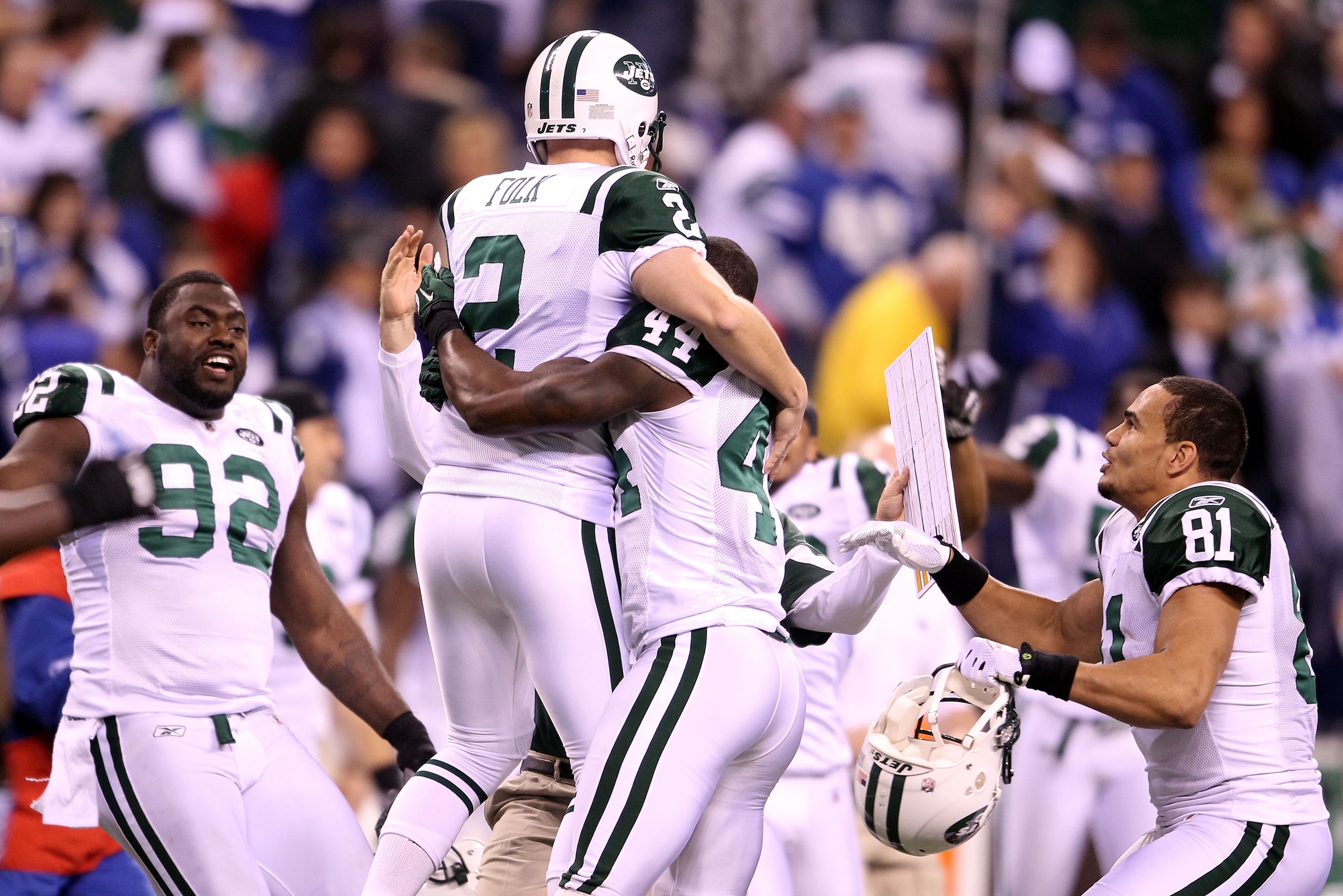 INDIANAPOLIS, IN - JANUARY 08:  Place kicker Nick Folk #2 of the New York Jets celebrates with Shaun Ellis #92, James Ihedigbo #44 and Dustin Keller #81 after Folk successfully kicked a game-winning a 32-yard field goal in the fourth quarter to win 17-16