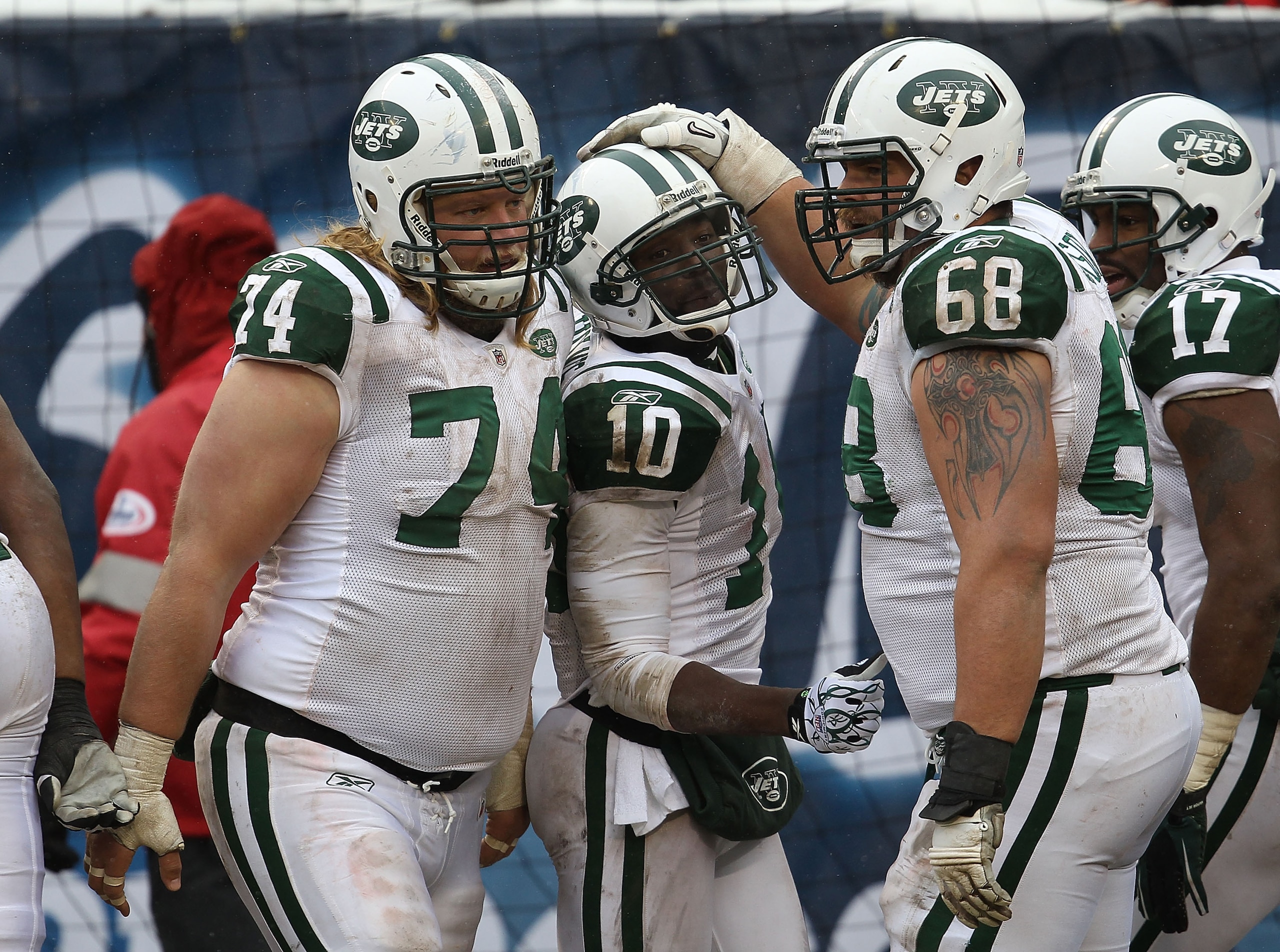 CHICAGO, IL - DECEMBER 26: Santonio Holmes #10 of the New York Jets is congratualted by Nick Mangold #74, Matt Slauson #68 and Braylon Edwards #17 after scoring a touchdown against the Chicago Bears at Soldier Field on December 26, 2010 in Chicago, Illino