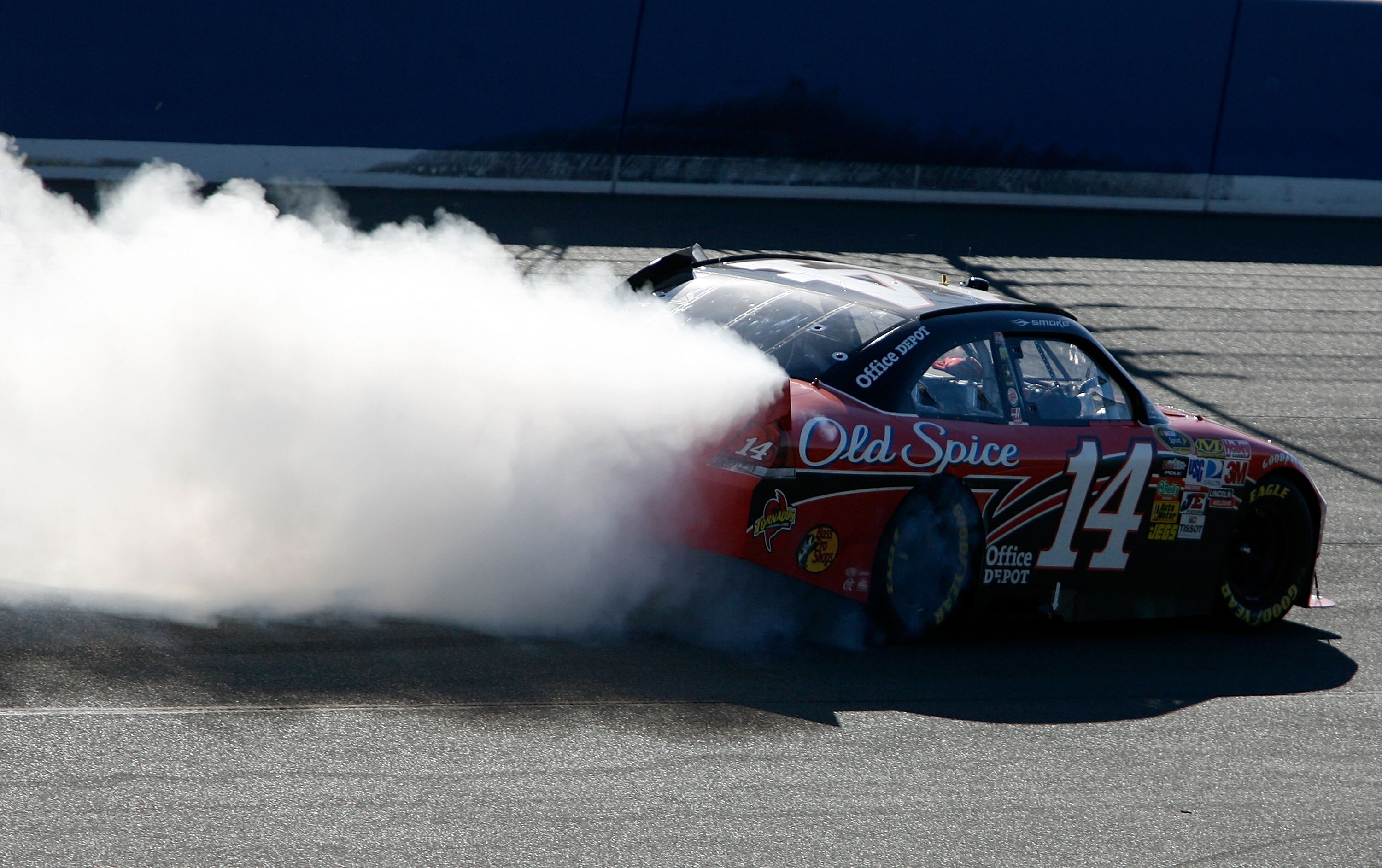 FONTANA, CA - OCTOBER 10:  Tony Stewart, driver of the #14 Office Depot Chevrolet, celebrates with a burnout after winning the NASCAR Sprint Cup Series Pepsi Max 400 on October 10, 2010 in Fontana, California.  (Photo by Tom Pennington/Getty Images for NA