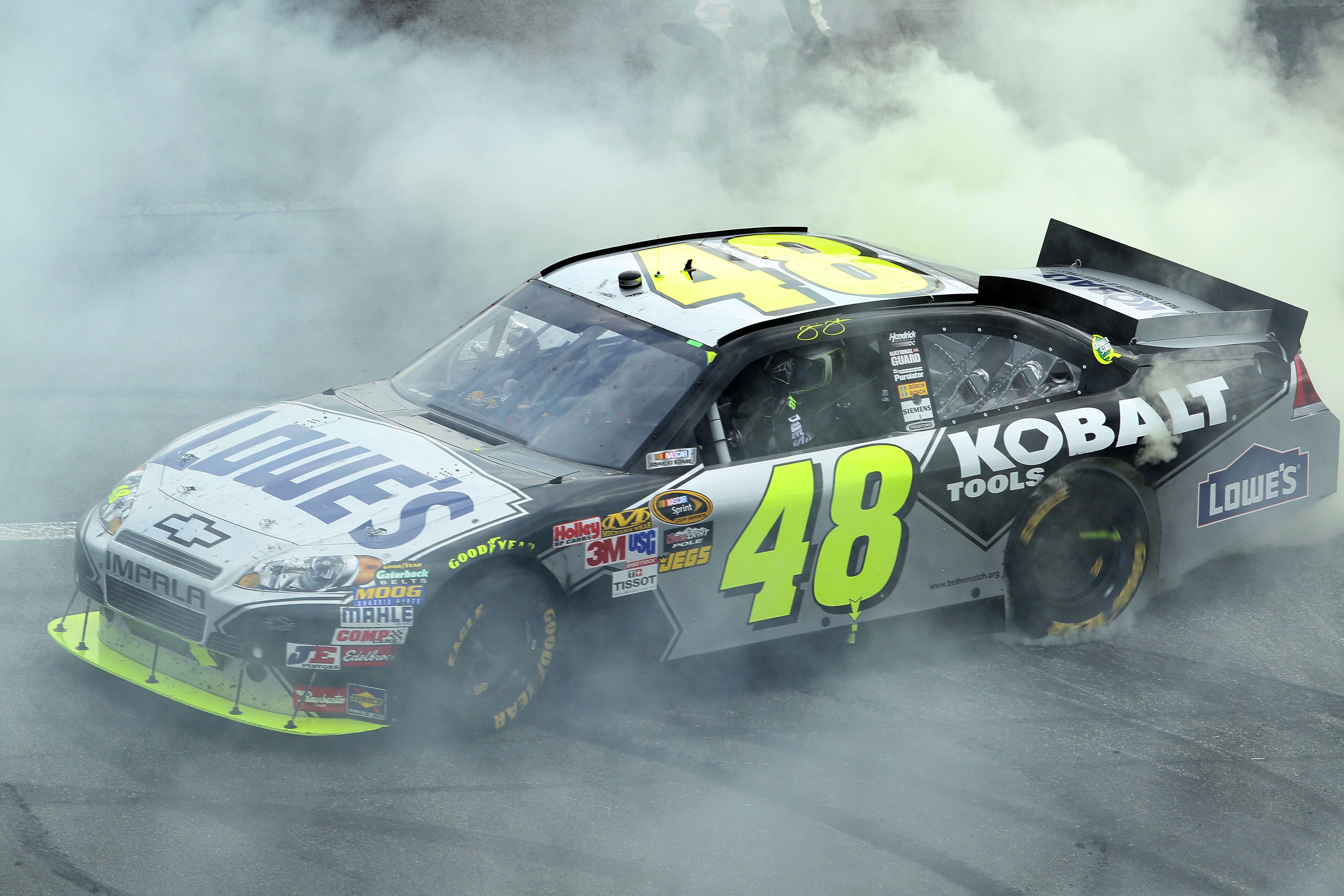 DOVER, DE - SEPTEMBER 26:  Jimmie Johnson, driver of the #48 Lowe's Chevrolet, does a burnout after winning the NASCAR Sprint Cup Series AAA 400 at Dover International Speedway on September 26, 2010 in Dover, Delaware.  (Photo by Nick Laham/Getty Images)