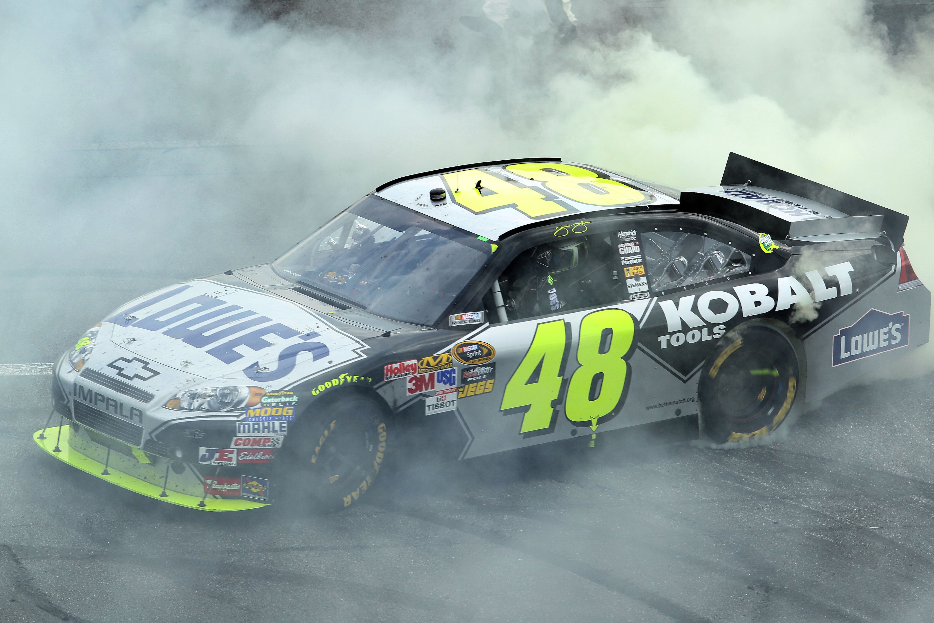 DOVER, DE - SEPTEMBER 26: Jimmie Johnson, driver of the #48 Lowe's Chevrolet, does a burnout after winning the NASCAR Sprint Cup Series AAA 400 at Dover International Speedway on September 26, 2010 in Dover, Delaware. (Photo by Nick Laham/Getty Images) DOVER, DE - SEPTEMBER 26: Jimmie Johnson, driver of the #48 Lowe's Chevrolet, does a burnout after winning the NASCAR Sprint Cup Series AAA 400 at Dover International Speedway on September 26, 2010 in Dover, Delaware. (Photo by Nick Laham/Getty Images)