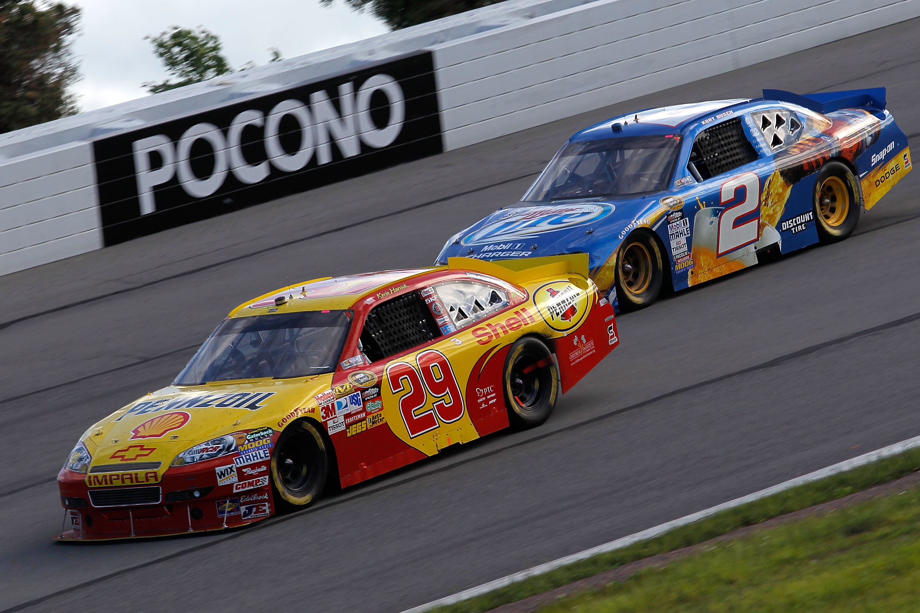 LONG POND, PA - JUNE 06:  Kevin Harvick, driver of the #29 Shell/Pennzoil Chevrolet, and Kurt Busch, driver of the #2 Miller Lite Dodge, drive during the NASCAR Sprint Cup Series Gillette Fusion ProGlide 500 at Pocono Raceway on June 6, 2010 in Long Pond,