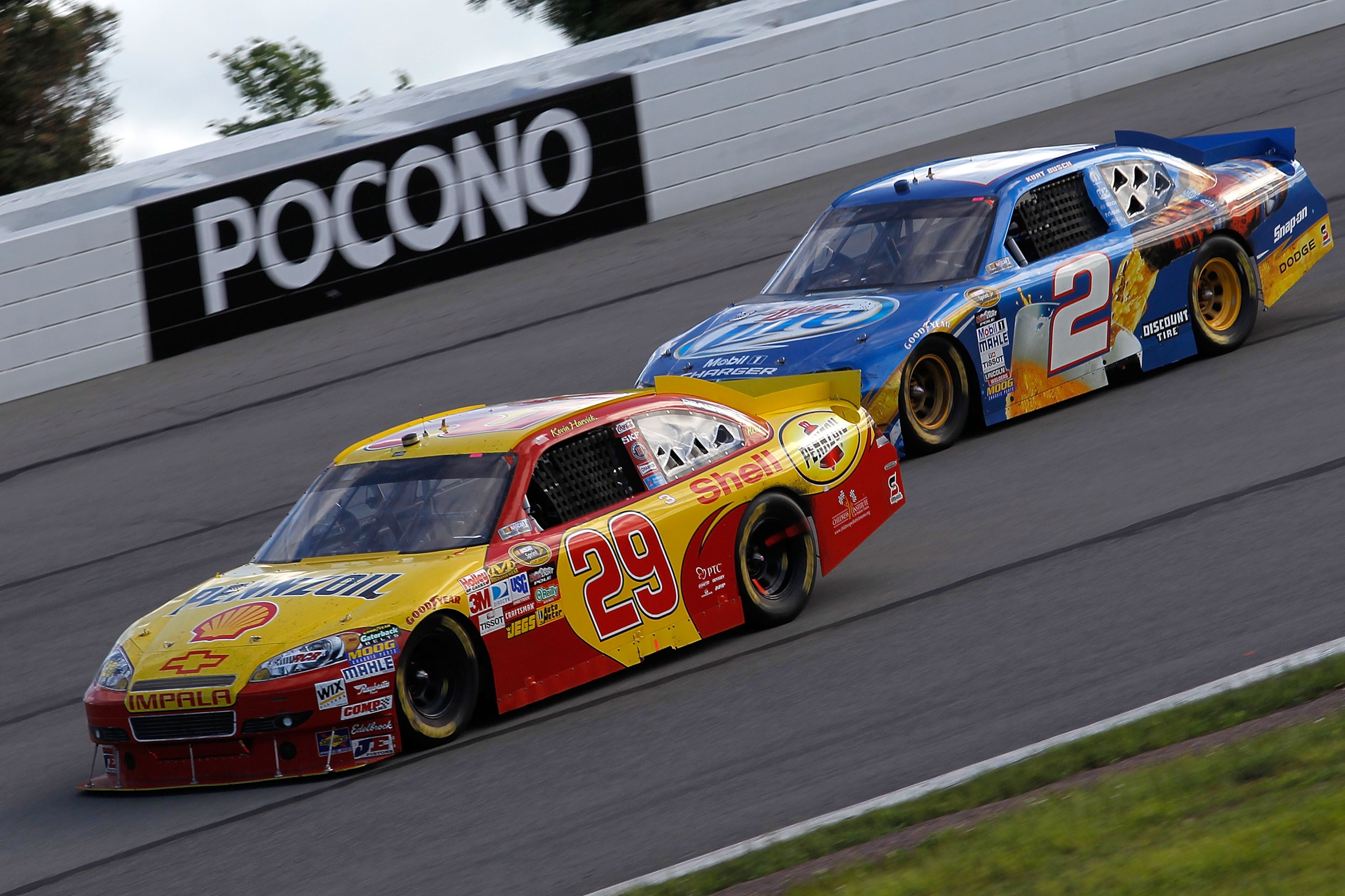 LONG POND, PA - JUNE 06: Kevin Harvick, driver of the #29 Shell/Pennzoil Chevrolet, and Kurt Busch, driver of the #2 Miller Lite Dodge, drive during the NASCAR Sprint Cup Series Gillette Fusion ProGlide 500 at Pocono Raceway on June 6, 2010 in Long Pond, LONG POND, PA - JUNE 06: Kevin Harvick, driver of the #29 Shell/Pennzoil Chevrolet, and Kurt Busch, driver of the #2 Miller Lite Dodge, drive during the NASCAR Sprint Cup Series Gillette Fusion ProGlide 500 at Pocono Raceway on June 6, 2010 in Long Pond,