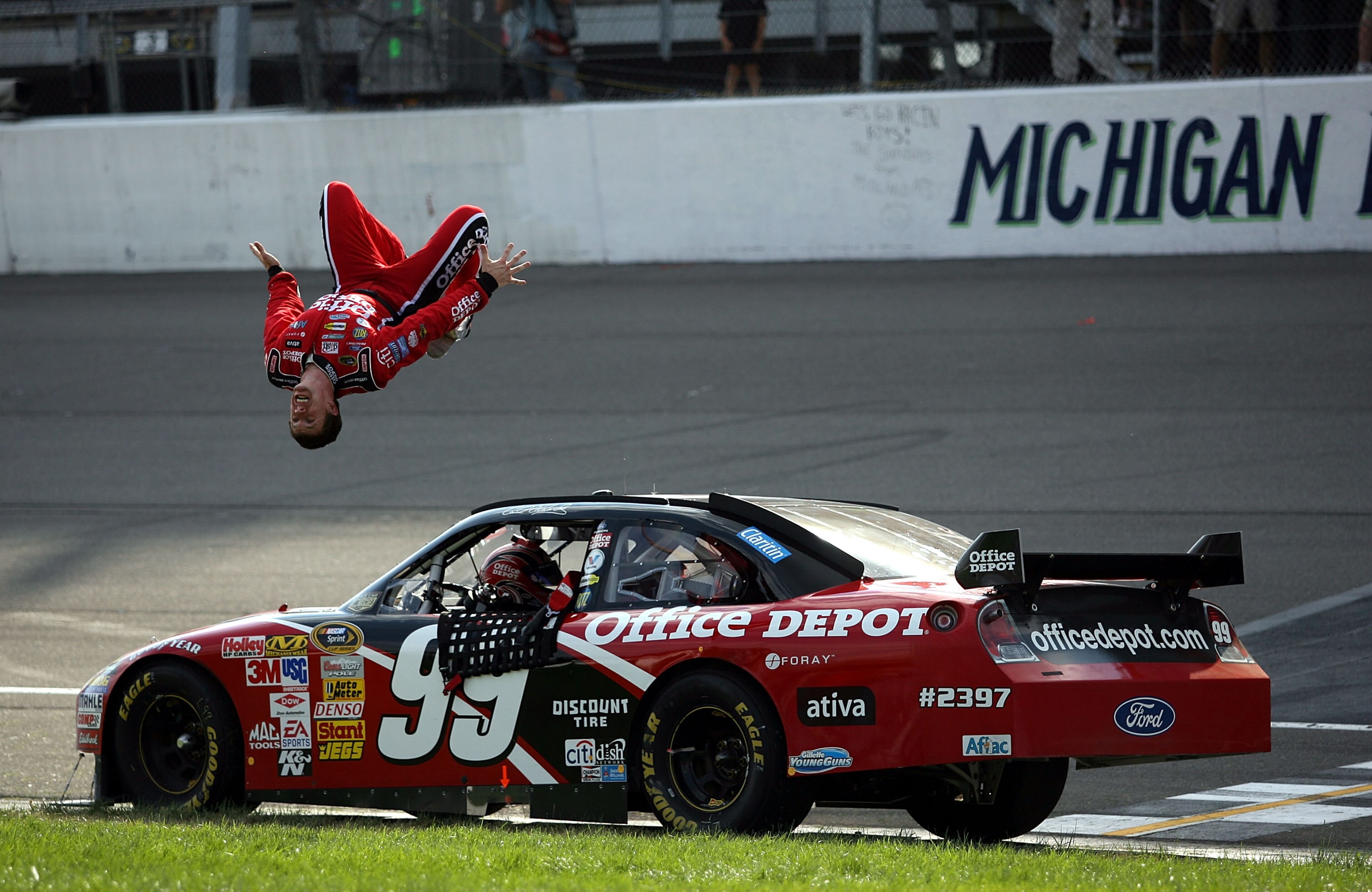 BROOKLYN, MI - AUGUST 17: Carl Edwards, driver of the #99 Office Depot Ford celebrates with a backflip from his car after winning the NASCAR Sprint Cup Series 3M Performance 400 at Michigan International Speedway on August 17, 2008 in Brooklyn, Michigan. BROOKLYN, MI - AUGUST 17: Carl Edwards, driver of the #99 Office Depot Ford celebrates with a backflip from his car after winning the NASCAR Sprint Cup Series 3M Performance 400 at Michigan International Speedway on August 17, 2008 in Brooklyn, Michigan.