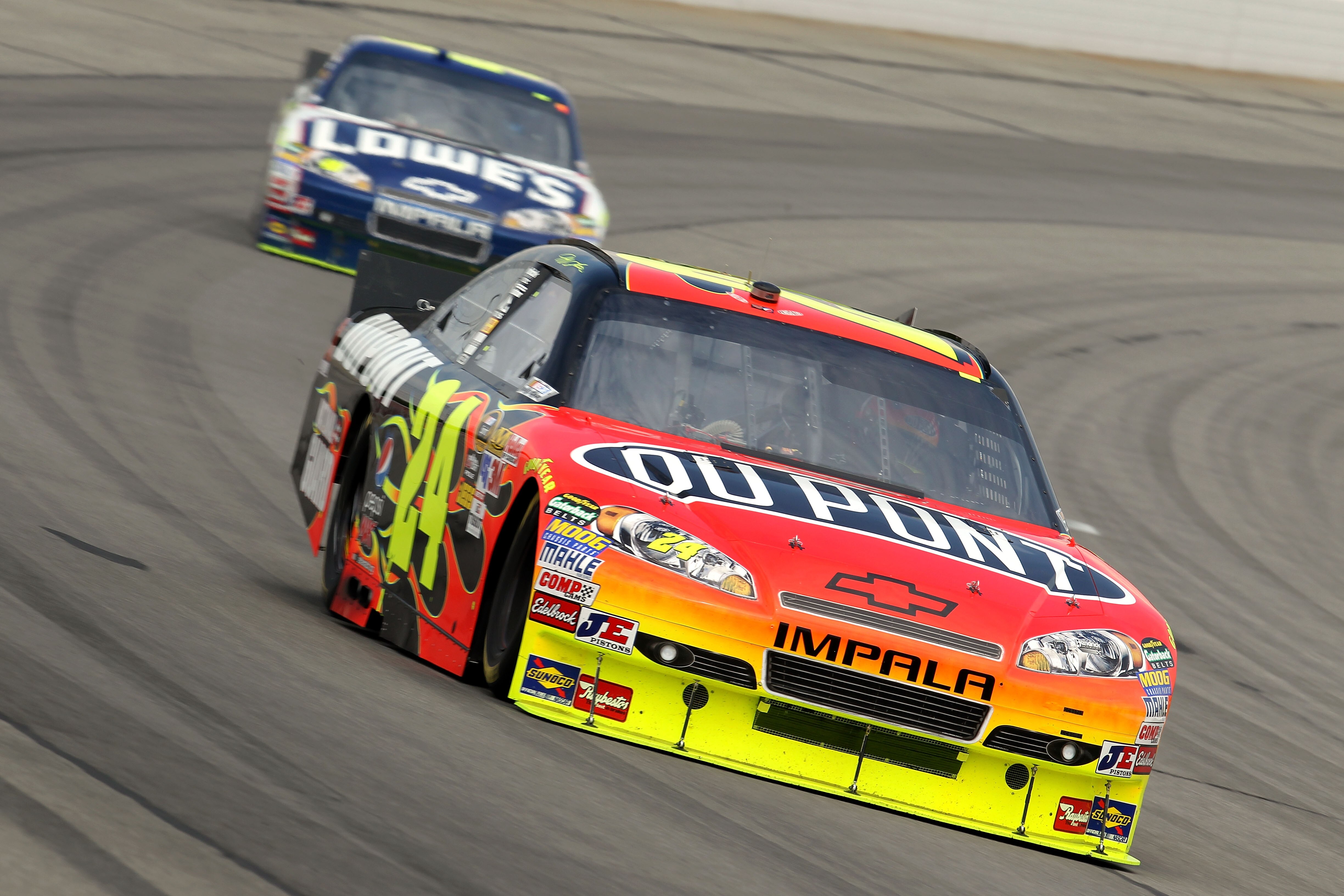 LONG POND, PA - AUGUST 01:  Jeff Gordon, driver of the #24 DuPont Chevrolet, leads Jimmie Johnson, driver of the #48 Lowe's Chevrolet, during the NASCAR Sprint Cup Series Sunoco Red Cross Pennsylvania 500 at Pocono Raceway on August 1, 2010 in Long Pond, 