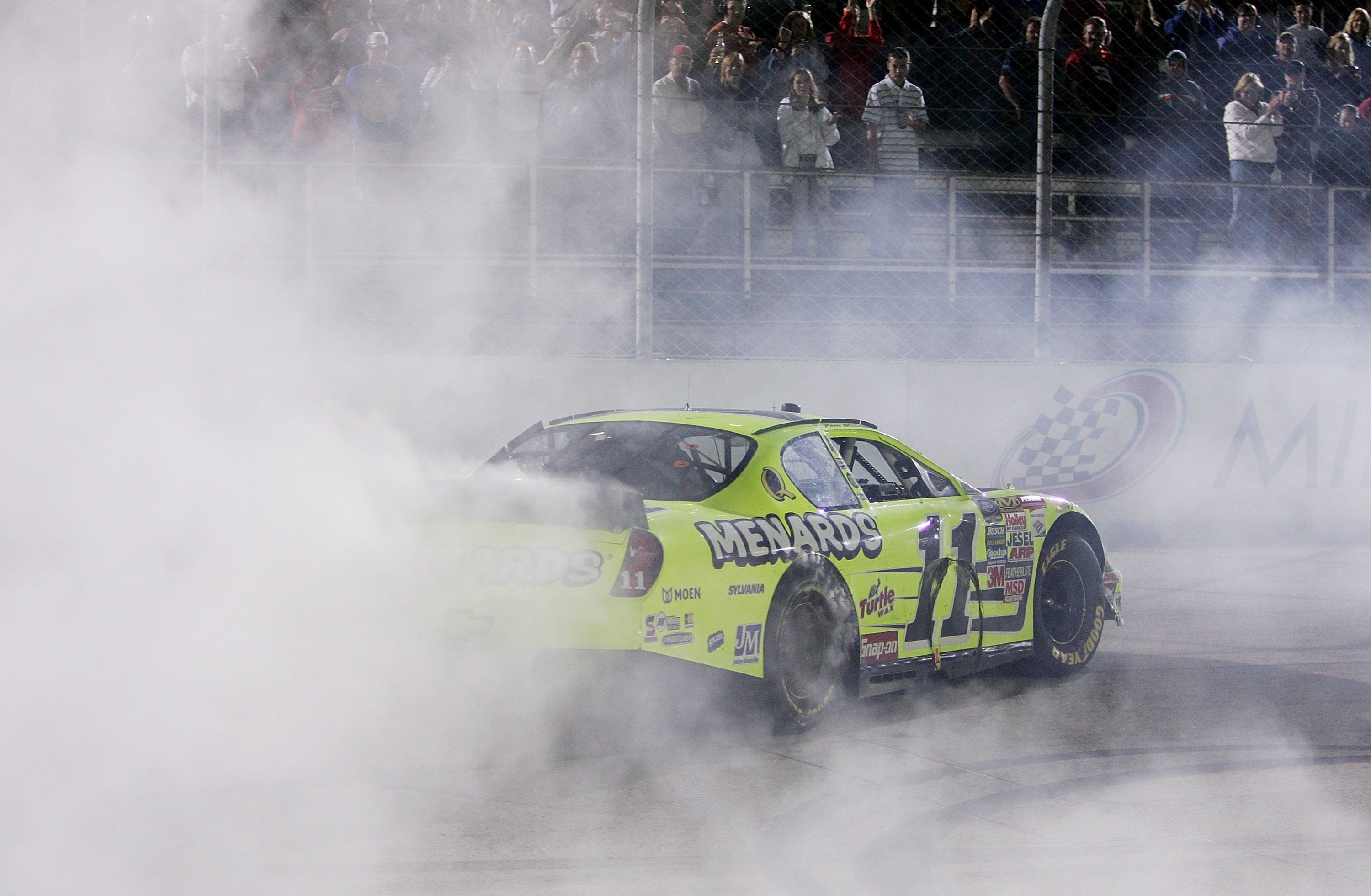 MILWAUKEE - JUNE 24: Paul Menard does a burnout in front of the grandstands after winning the AT&T 250 race on June 24, 2006 at the Milwaukee Mile in West Allis, Wisconsin. (Photo by Jonathan Daniel/Getty Images)