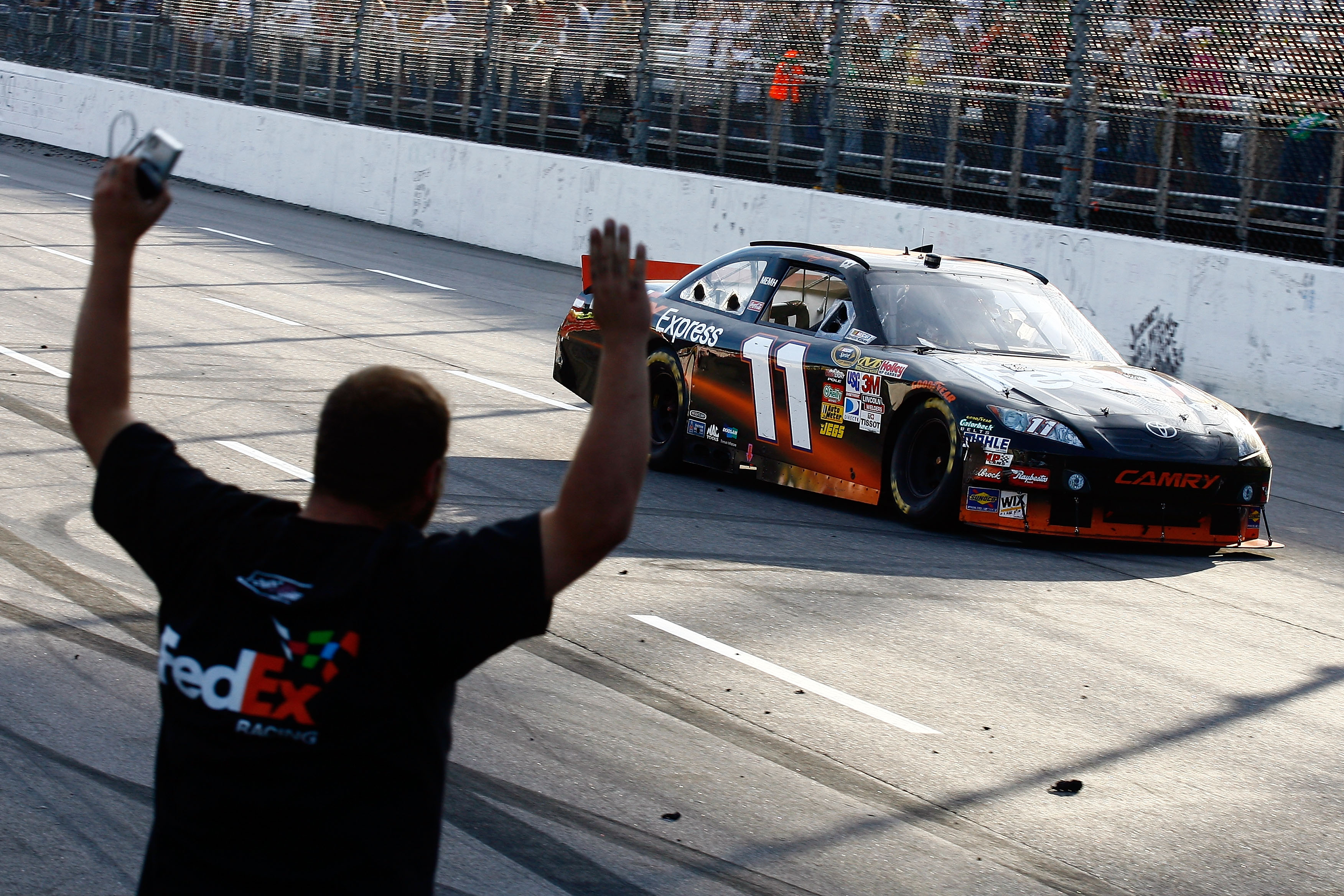 MARTINSVILLE, VA - OCTOBER 24:  Denny Hamlin, driver of the #11 FedEx Express Toyota, does a victory lap after winning the NASCAR Sprint Cup Series TUMS Fast Relief 500 at Martinsville Speedway on October 24, 2010 in Martinsville, Virginia.  (Photo by Jas