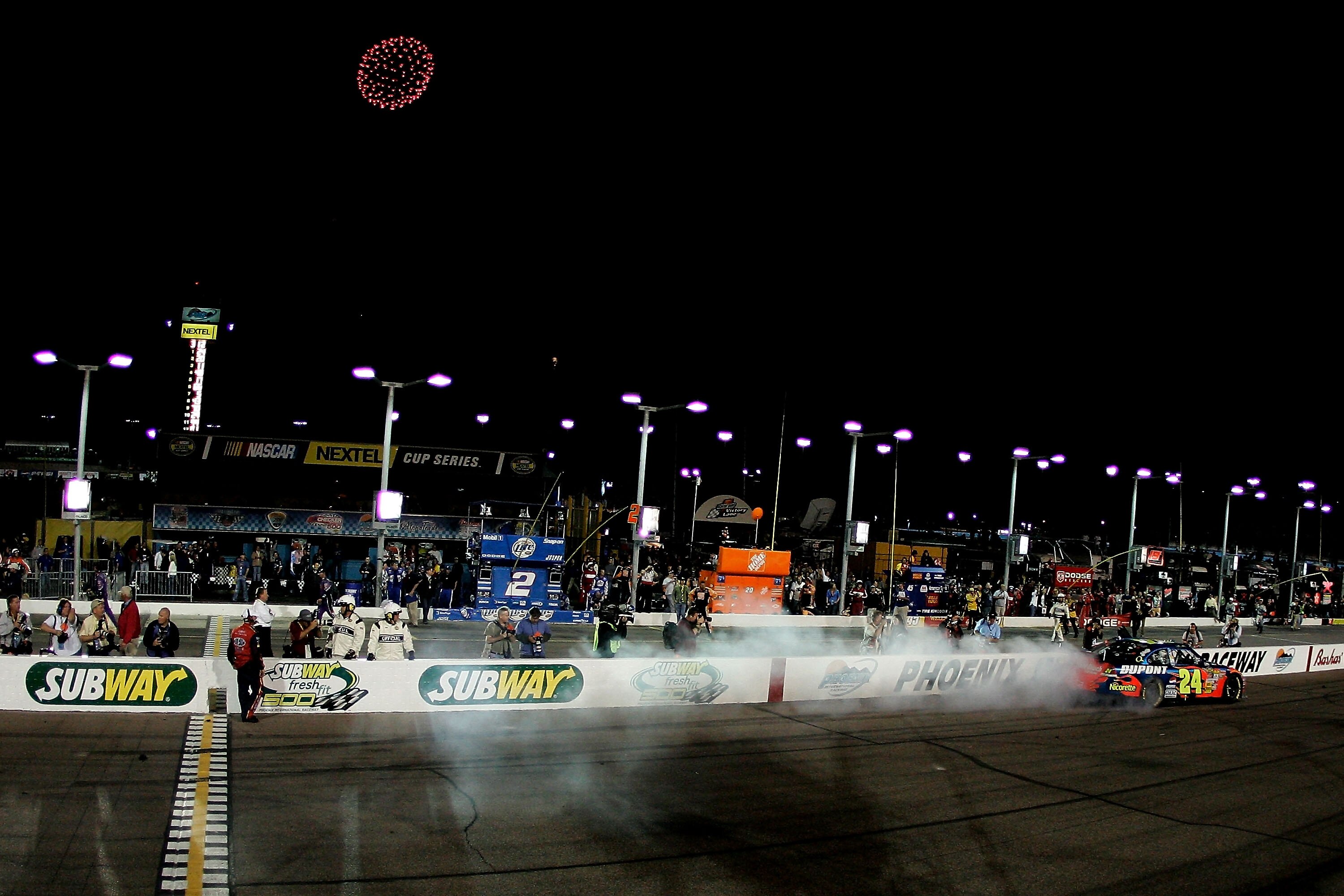 AVONDALE, AZ - APRIL 21:  Jeff Gordon, driver of the #24 DuPont Chevrolet, does a burnout after winning the NASCAR Nextel Cup Series Subway Fresh Fit 500 at Phoenix International Raceway on April 21, 2007 in Avondale, Arizona.  (Photo by Jason Smith/Getty