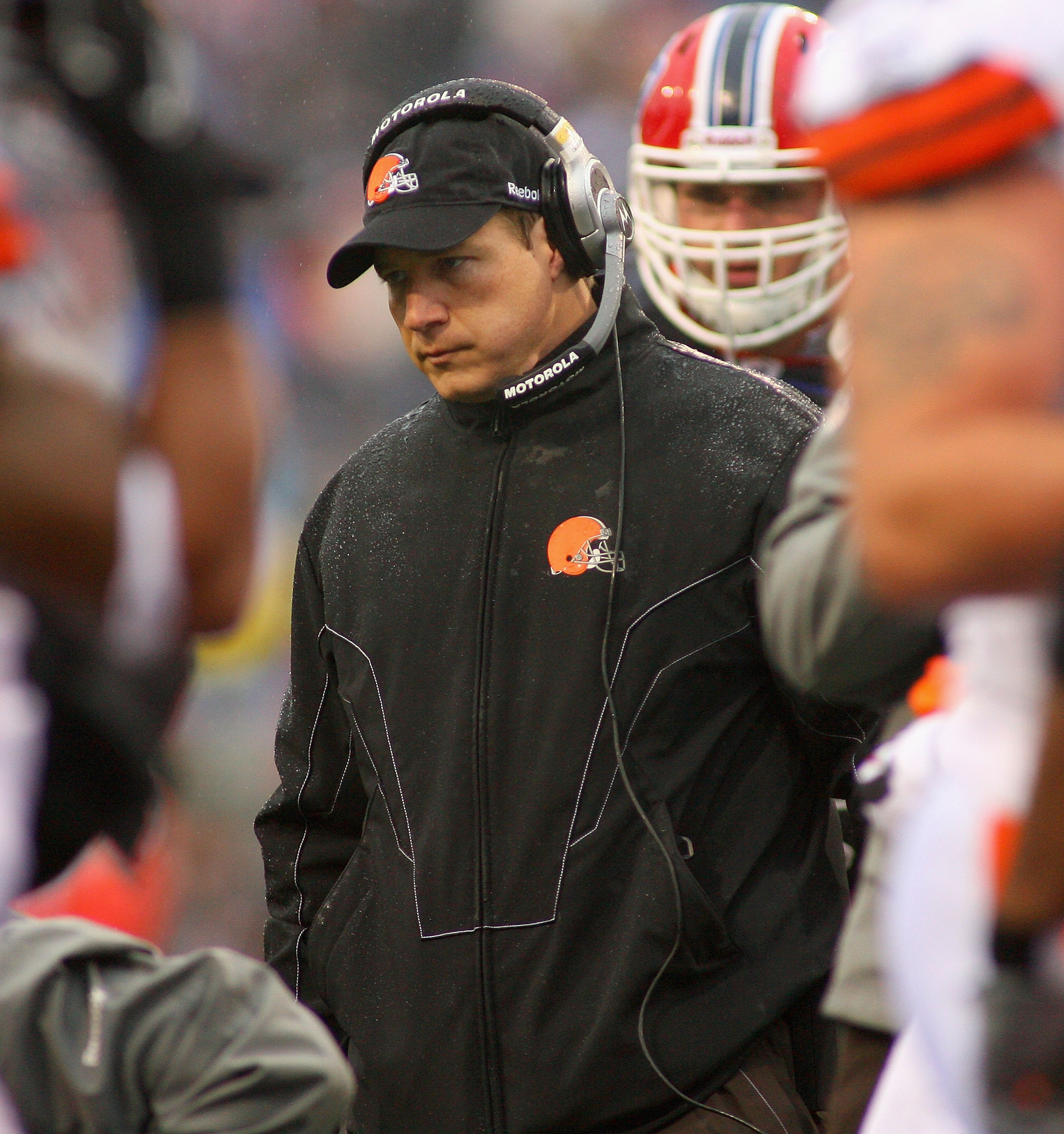 ORCHARD PARK, NY - DECEMBER 12: Eric Mangini, head coach of the Cleveland Browns stands over injured Browns player David Bowens #86 during a timeout against the Buffalo Bills at Ralph Wilson Stadium on December 12, 2010 in Orchard Park, New York.  (Photo