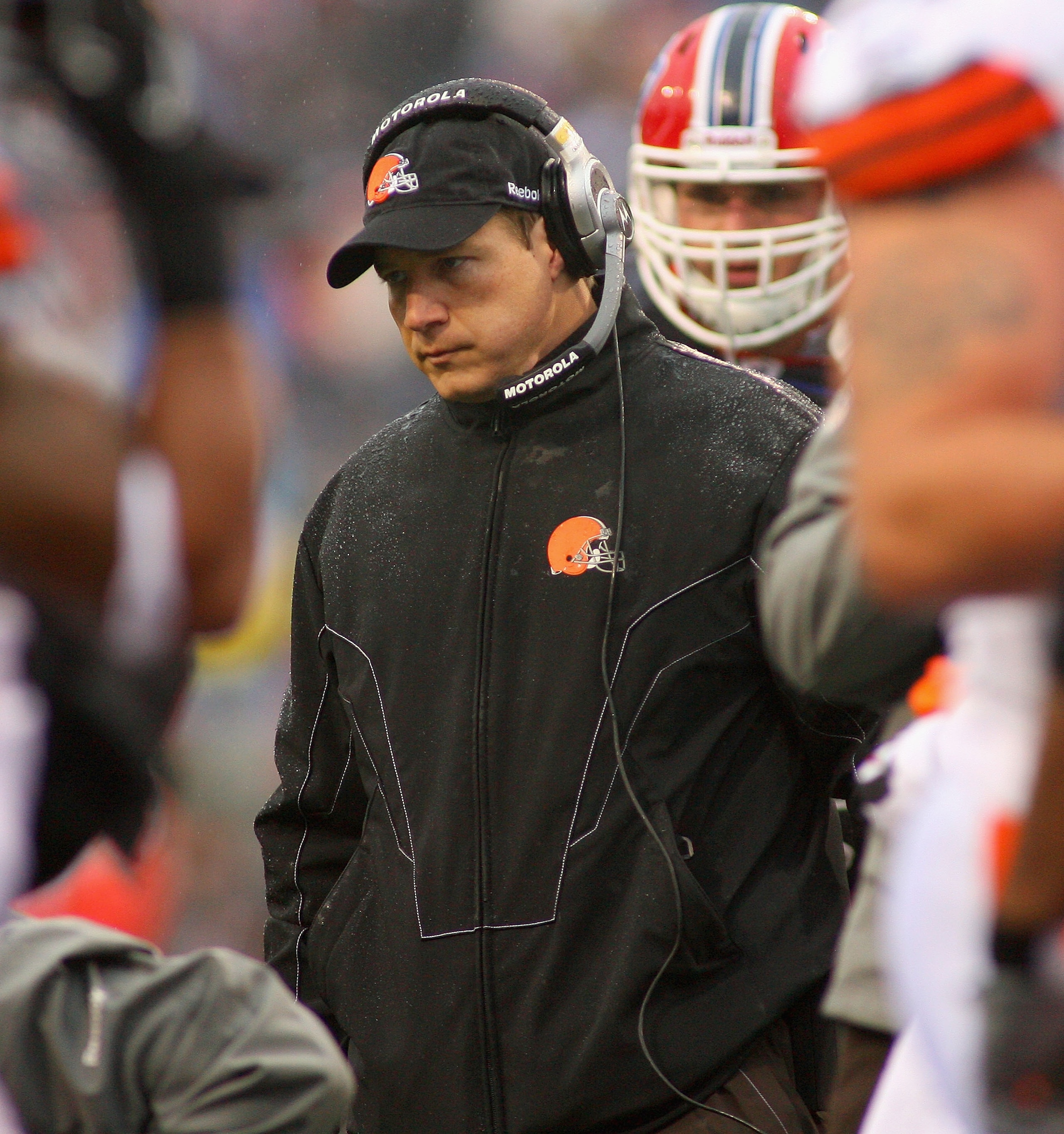 ORCHARD PARK, NY - DECEMBER 12: Eric Mangini, head coach of the Cleveland Browns stands over injured Browns player David Bowens #86 during a timeout against the Buffalo Bills at Ralph Wilson Stadium on December 12, 2010 in Orchard Park, New York.  (Photo