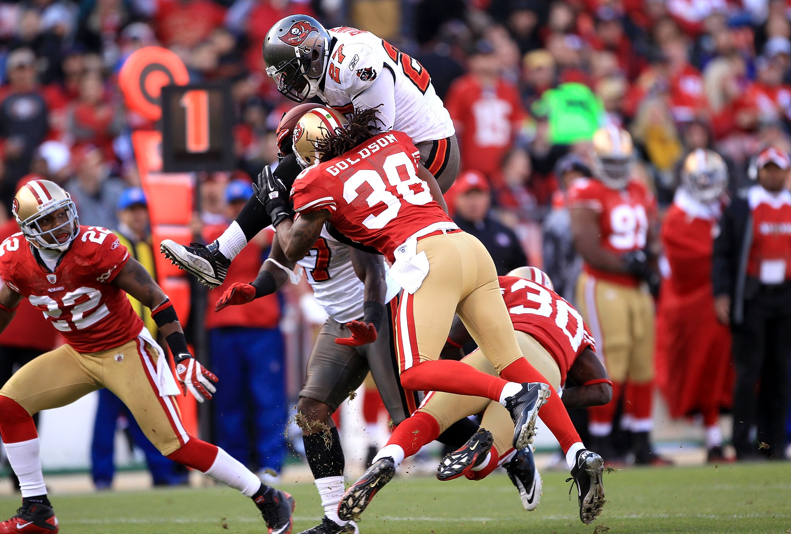SAN FRANCISCO - NOVEMBER 21: LeGarrette Blount #27 of the Tampa Bay Buccaneers leaps over Reggie Smith #30 when he is hit by Dashon Goldson #38 of the San Francisco 49ers at Candlestick Park on November 21, 2010 in San Francisco, California. (Photo by E SAN FRANCISCO - NOVEMBER 21: LeGarrette Blount #27 of the Tampa Bay Buccaneers leaps over Reggie Smith #30 when he is hit by Dashon Goldson #38 of the San Francisco 49ers at Candlestick Park on November 21, 2010 in San Francisco, California. (Photo by E