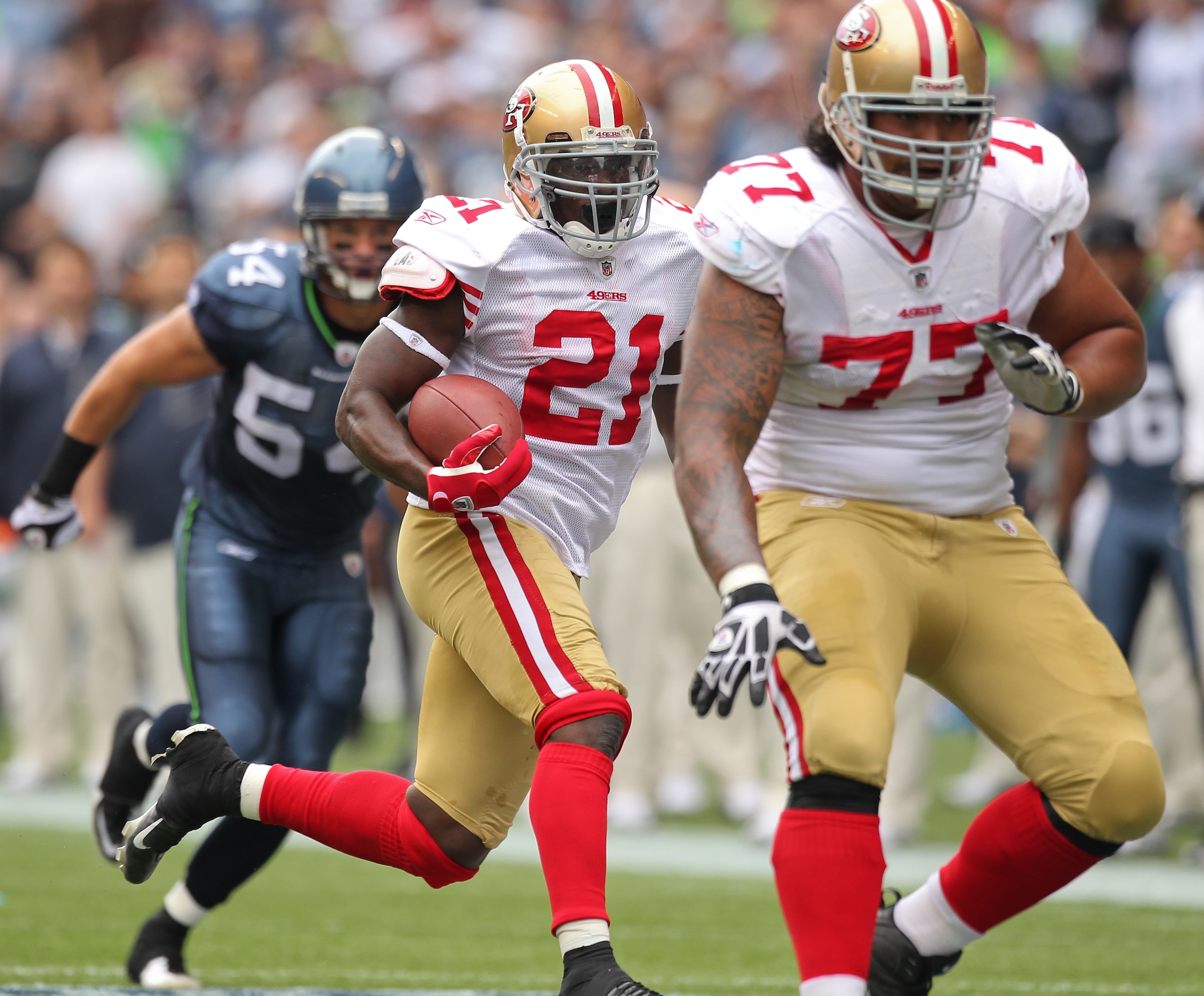 SEATTLE - SEPTEMBER 12: Running back Frank Gore #21 of the San Francisco 49ers rushes as Mike Iupati #77 blocks for him during the NFL season opener against the Seattle Seahawks at Qwest Field on September 12, 2010 in Seattle, Washington. (Photo by Otto SEATTLE - SEPTEMBER 12: Running back Frank Gore #21 of the San Francisco 49ers rushes as Mike Iupati #77 blocks for him during the NFL season opener against the Seattle Seahawks at Qwest Field on September 12, 2010 in Seattle, Washington. (Photo by Otto
