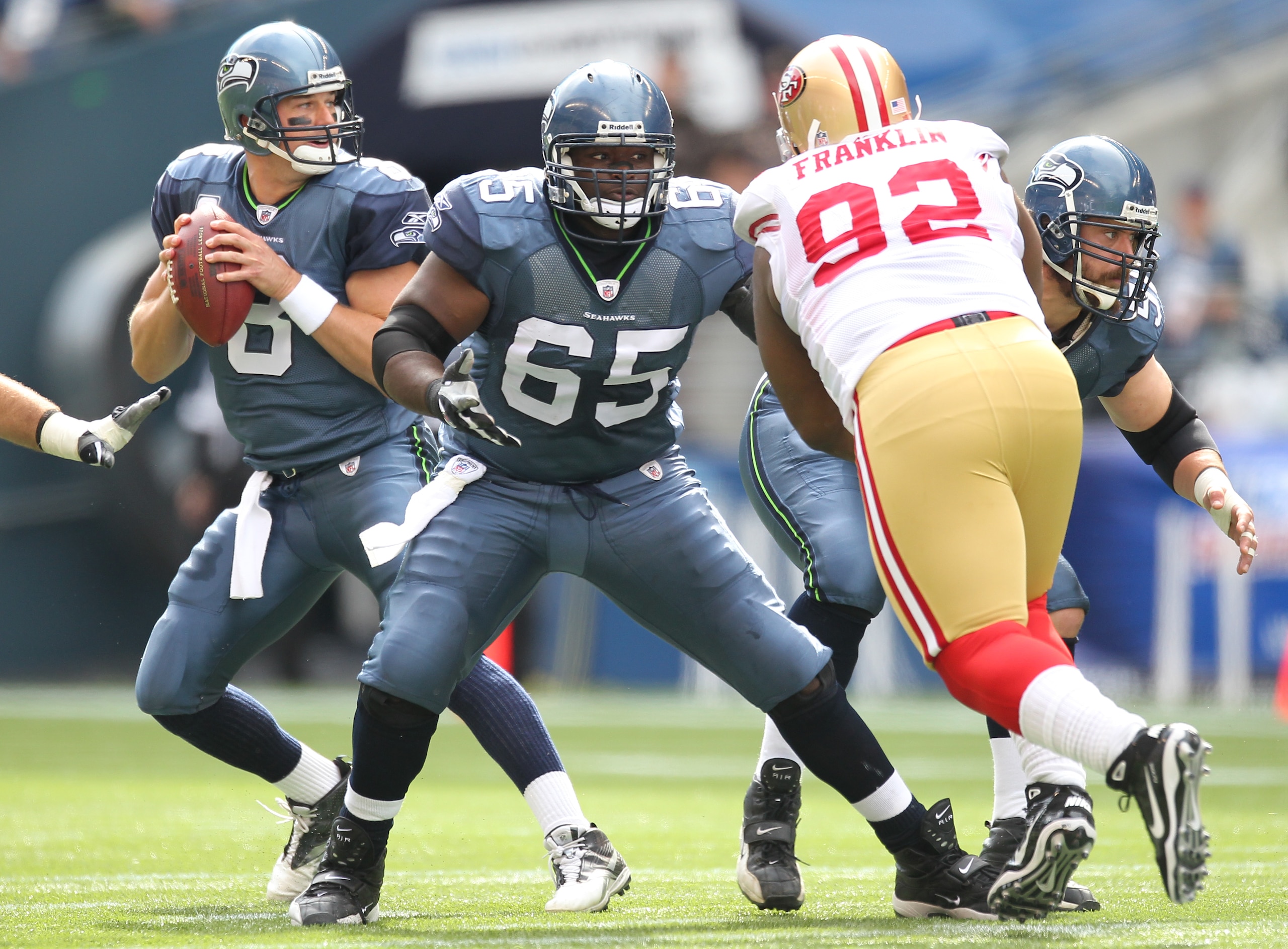 SEATTLE - SEPTEMBER 12: Quarterback Matt Hasselbeck #8 of the Seattle Seahawks drops back to pass as Chris Spencer #65 and Ben Hamilton #50 defend against Aubrayo Franklin #92 of the San Francisco 49ers during the NFL season opener against at Qwest Field SEATTLE - SEPTEMBER 12: Quarterback Matt Hasselbeck #8 of the Seattle Seahawks drops back to pass as Chris Spencer #65 and Ben Hamilton #50 defend against Aubrayo Franklin #92 of the San Francisco 49ers during the NFL season opener against at Qwest Field