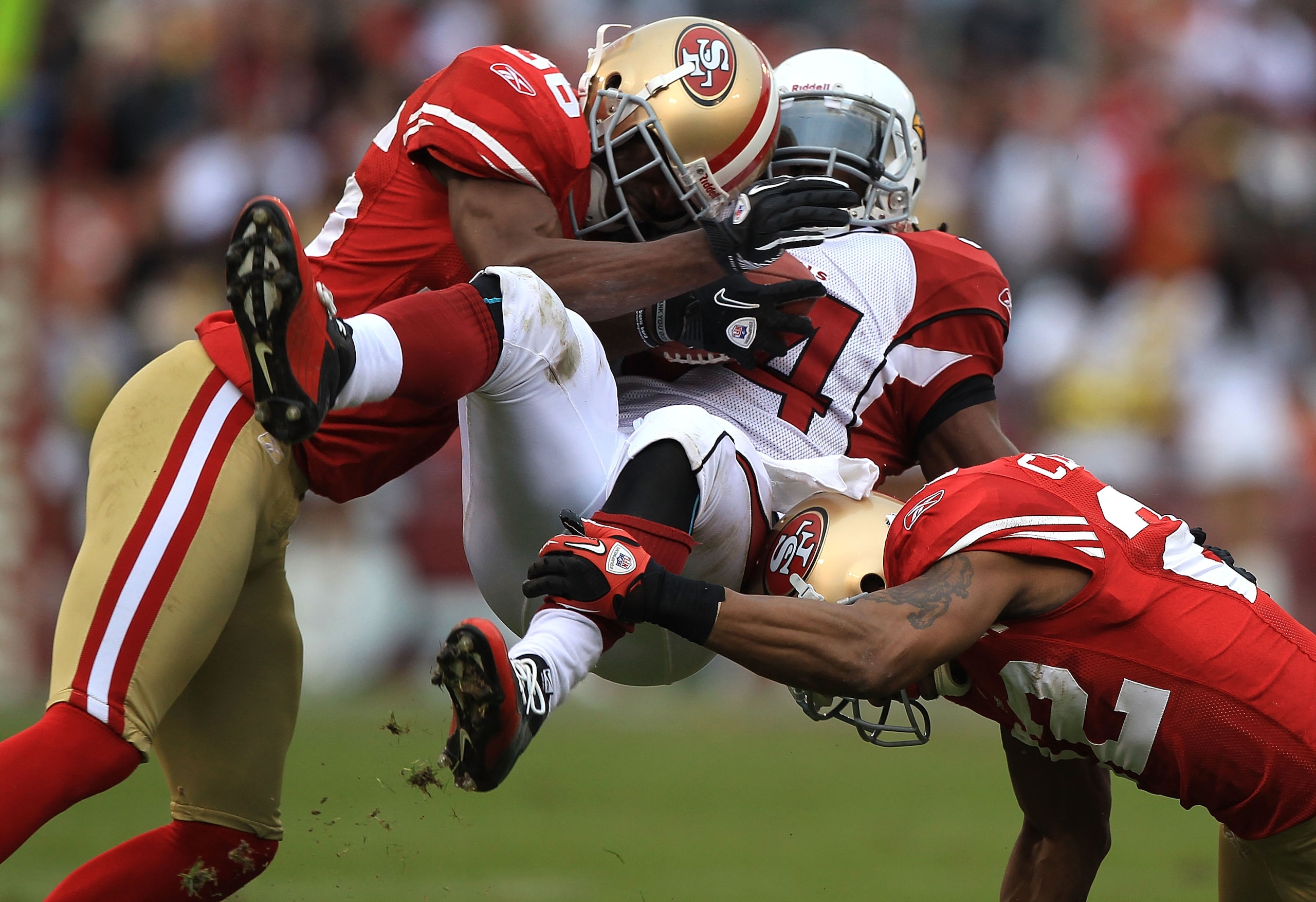 SAN FRANCISCO, CA - JANUARY 2: Tim Hightower #34 of the Arizona Cardinals is tackled by Nate Clements #22 and Shawntae Spencer #36 of the San Francisco 49ers during an NFL game at Candlestick Park on January 2, 2011 in San Francisco, California.(Photo b SAN FRANCISCO, CA - JANUARY 2: Tim Hightower #34 of the Arizona Cardinals is tackled by Nate Clements #22 and Shawntae Spencer #36 of the San Francisco 49ers during an NFL game at Candlestick Park on January 2, 2011 in San Francisco, California.(Photo b
