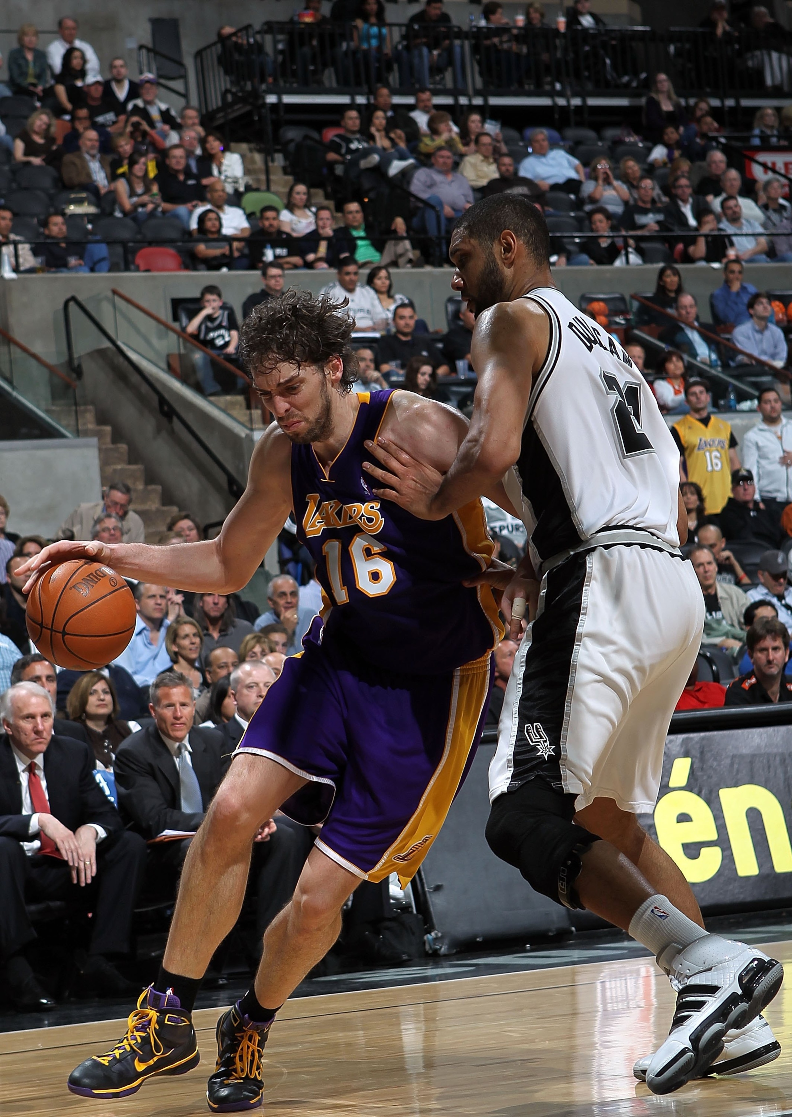 SAN ANTONIO - MARCH 24: Forward Pau Gasol #16 of the Los Angeles Lakers dribbles the ball past Tim Duncan #21 of the San Antonio Spurs at AT&T Center on March 24, 2010 in San Antonio, Texas. NOTE TO USER: User expressly acknowledges and agrees that, by SAN ANTONIO - MARCH 24: Forward Pau Gasol #16 of the Los Angeles Lakers dribbles the ball past Tim Duncan #21 of the San Antonio Spurs at AT&T Center on March 24, 2010 in San Antonio, Texas. NOTE TO USER: User expressly acknowledges and agrees that, by