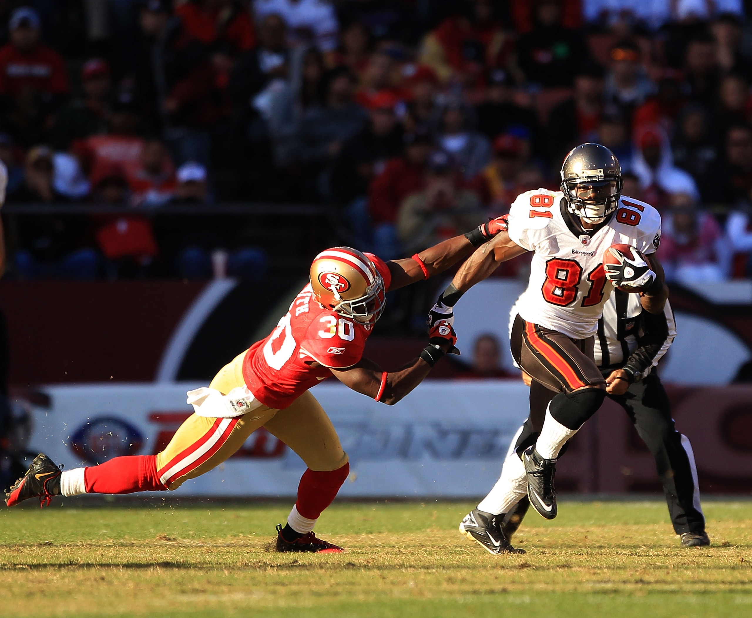SAN FRANCISCO - NOVEMBER 21: Micheal Spurlock #81 of the Tampa Bay Buccaneers tries turnover outrun Reggie Smith #30 of the San Francisco 49ers at Candlestick Park on November 21, 2010 in San Francisco, California. (Photo by Ezra Shaw/Getty Images) SAN FRANCISCO - NOVEMBER 21: Micheal Spurlock #81 of the Tampa Bay Buccaneers tries turnover outrun Reggie Smith #30 of the San Francisco 49ers at Candlestick Park on November 21, 2010 in San Francisco, California. (Photo by Ezra Shaw/Getty Images)
