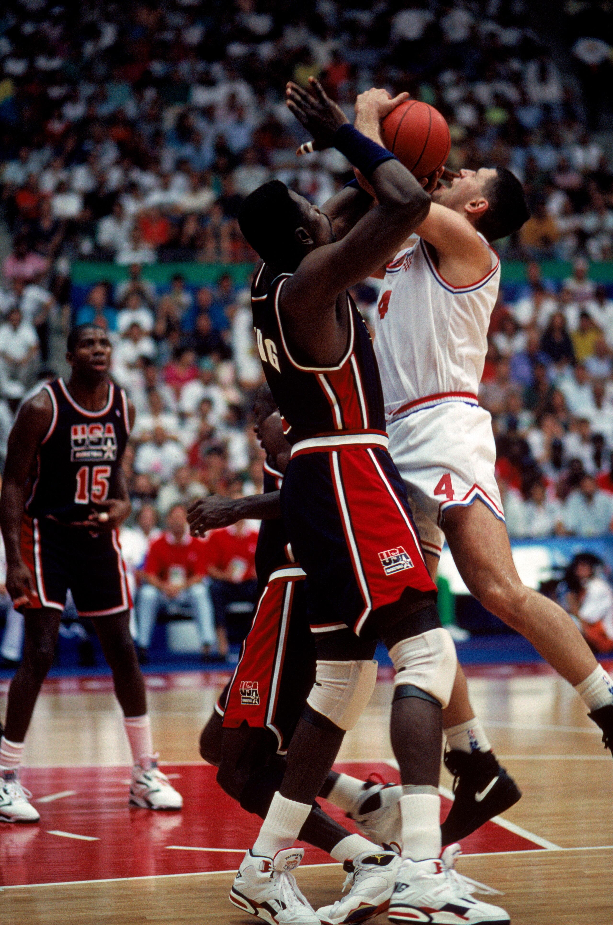 BARCELONA, SPAIN - JULY 27:  Drazen Petrovic #4 of Croatia is blocked by Patrick Ewing #6 of the United States during the 1992 Olympic game on July 27, 1992 in Barcelona, Spain. The 'Dream Team' defeated Croatia 103-70. NOTE TO USER: User expressly acknow