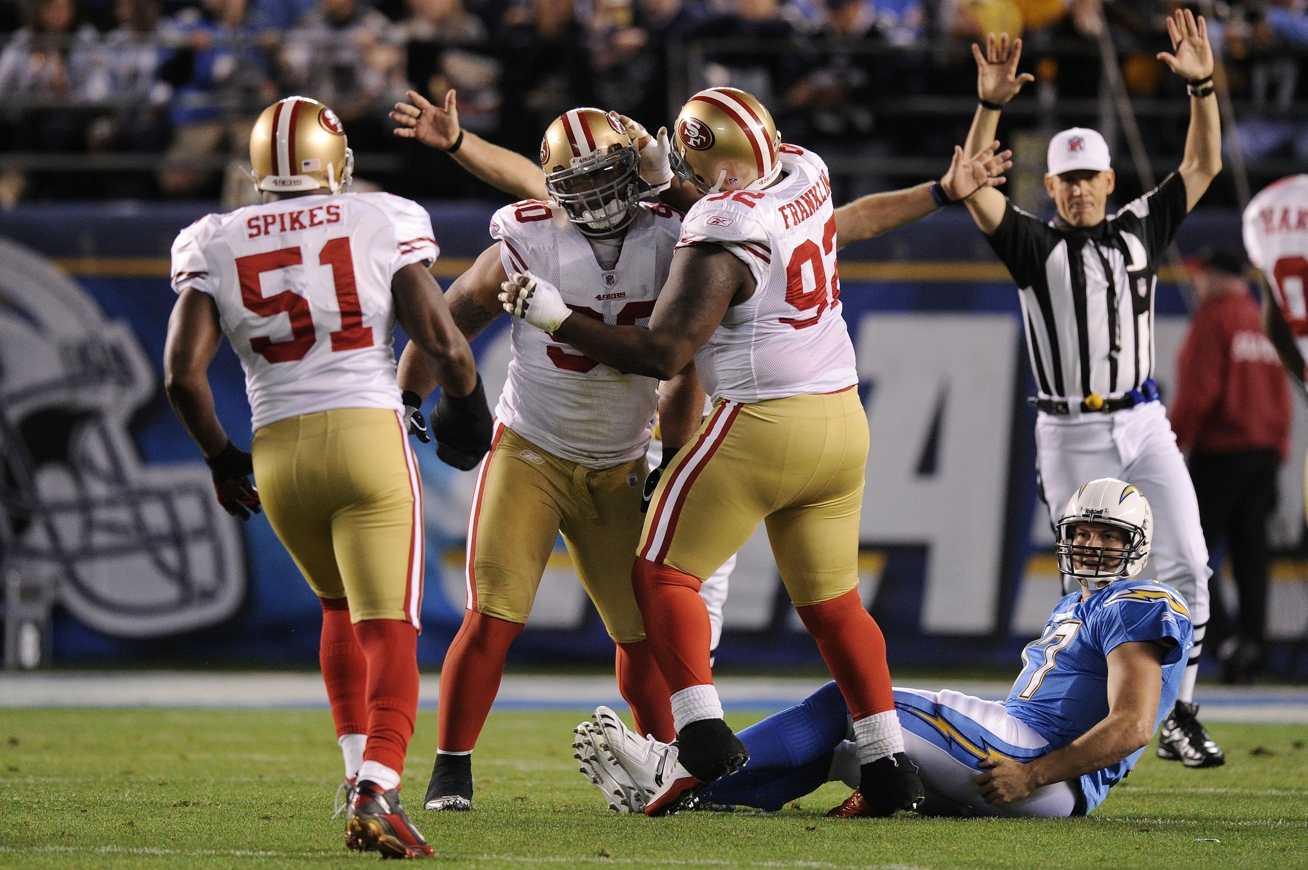 SAN DIEGO, CA - DECEMBER 16:  Defensive tackle Isaac Sopoaga #90 of the San Francisco 49ers celebrates with teammates after sacking quarterback Philip Rivers #17 of the San Diego Chargers at Qualcomm Stadium on December 16, 2010 in San Diego, California.