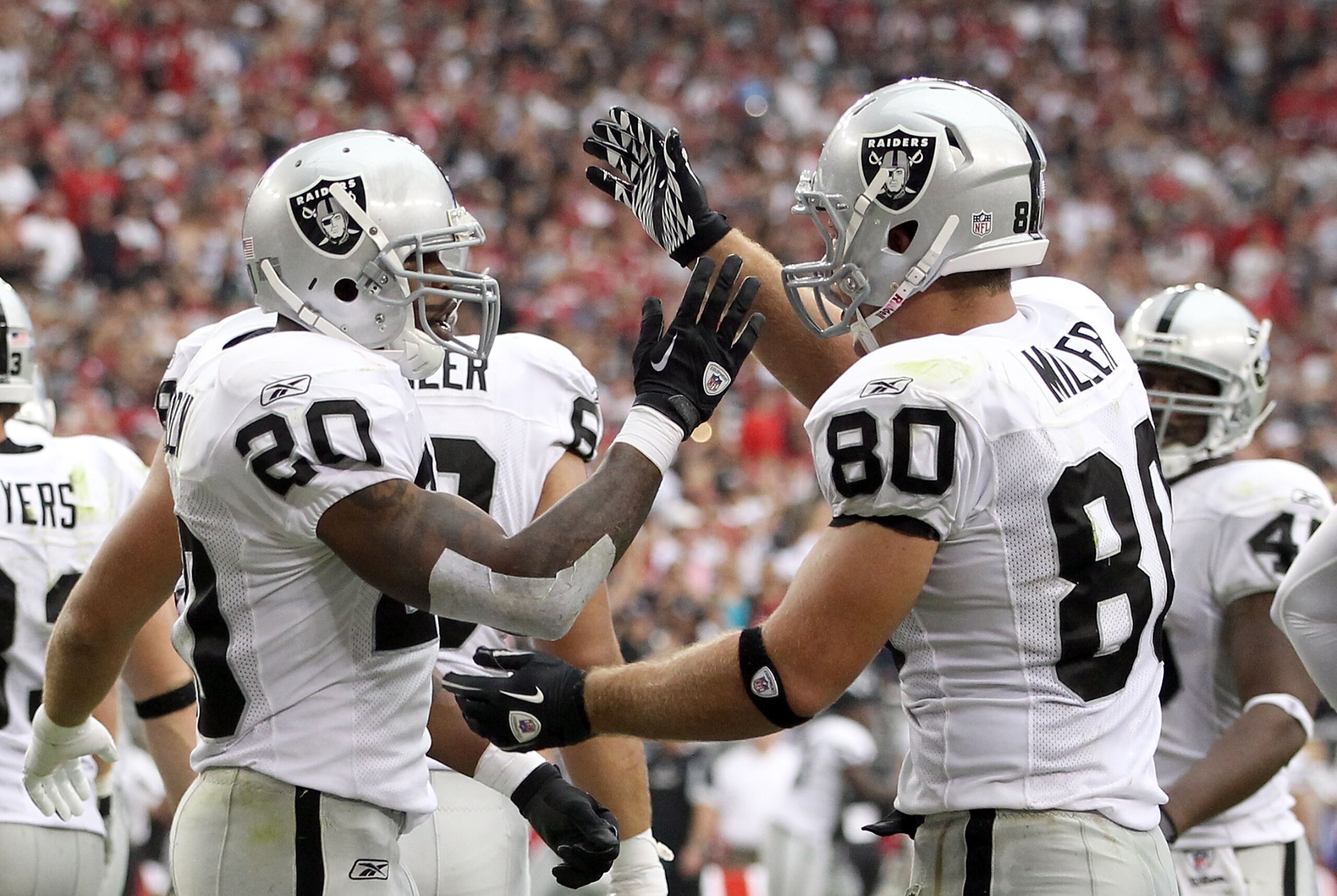 GLENDALE, AZ - SEPTEMBER 26: Runningback Darren McFadden #20 of the Oakland Raiders celebrates with teammate Zach Miller #80 after McFadden scored a 2 yard rushing touchdown against the Arizona Cardinals during the second quarter of the NFL game at the U GLENDALE, AZ - SEPTEMBER 26: Runningback Darren McFadden #20 of the Oakland Raiders celebrates with teammate Zach Miller #80 after McFadden scored a 2 yard rushing touchdown against the Arizona Cardinals during the second quarter of the NFL game at the U