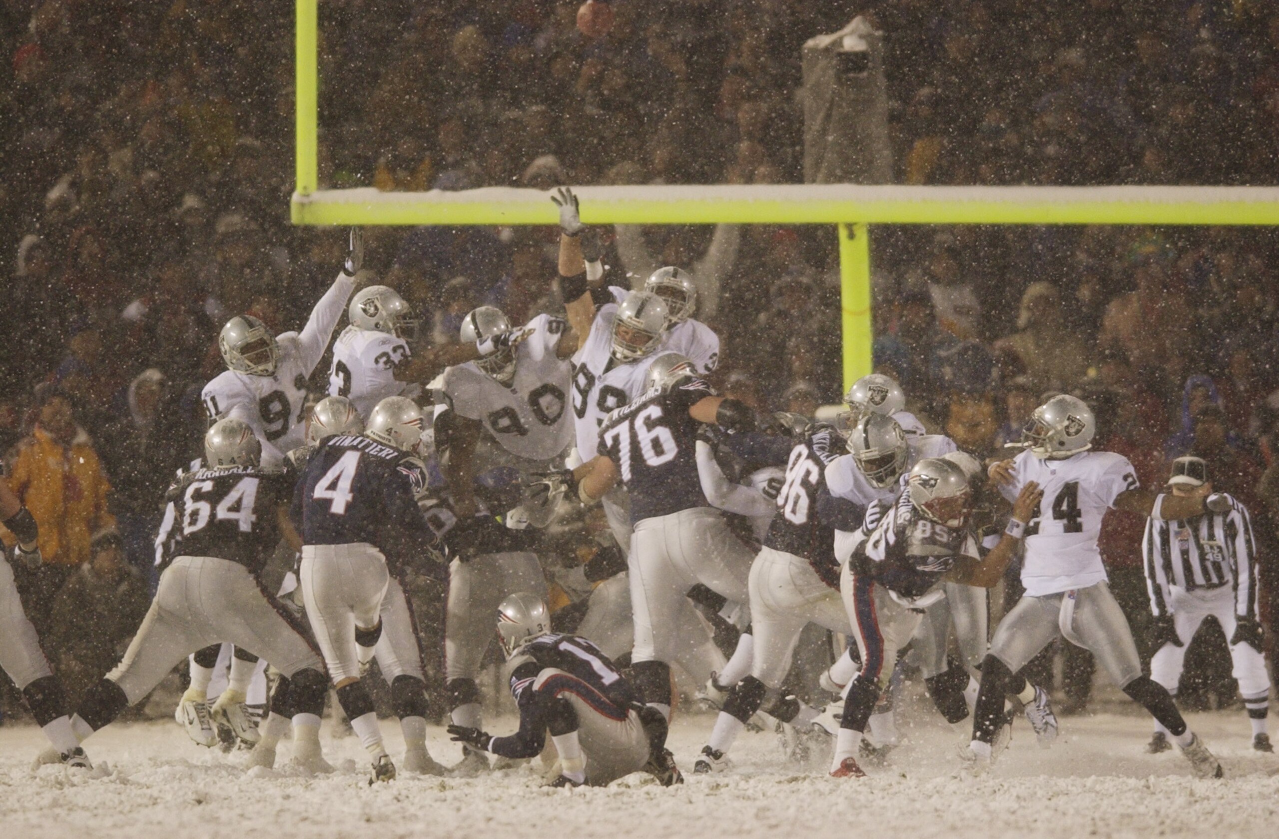 19 Jan 2002 : Adam Vinatieri #4 of the New England Patriots kicks the game winning field goal against the Oakland Raiders during the AFC Playoff game at Foxboro Stadium in Foxboro, Massachusettes. DIGITAL IMAGE. Mandatory Credit : Ezra Shaw/ Getty Images