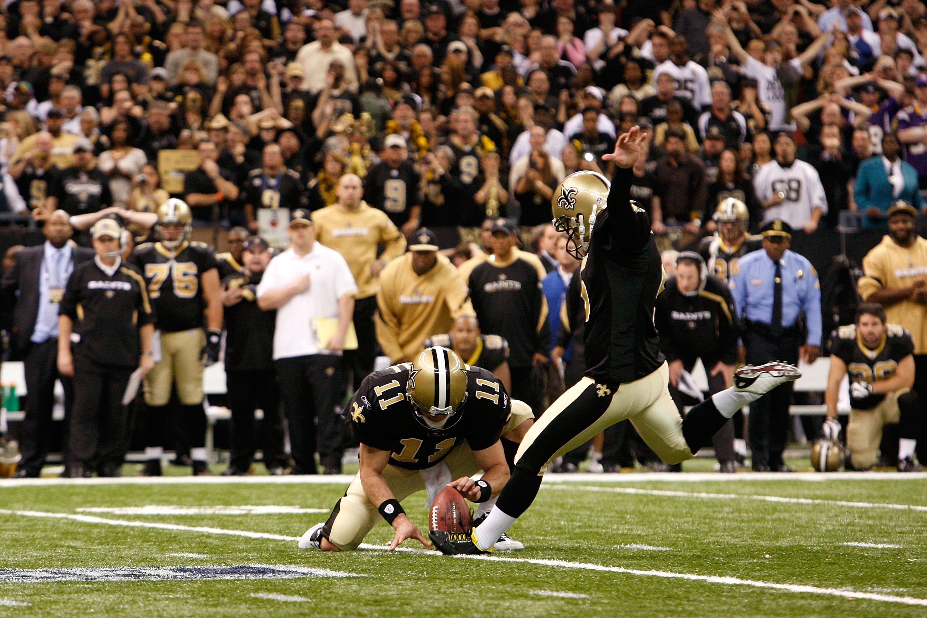NEW ORLEANS - JANUARY 24:  Kicker Garrett Hartley #5 of the New Orleans Saints successfully kicks a 40-yard game-winning field goal in overtime from the hold of Mark Brunell #11 against the Minnesota Vikings during the NFC Championship Game at the Louisia