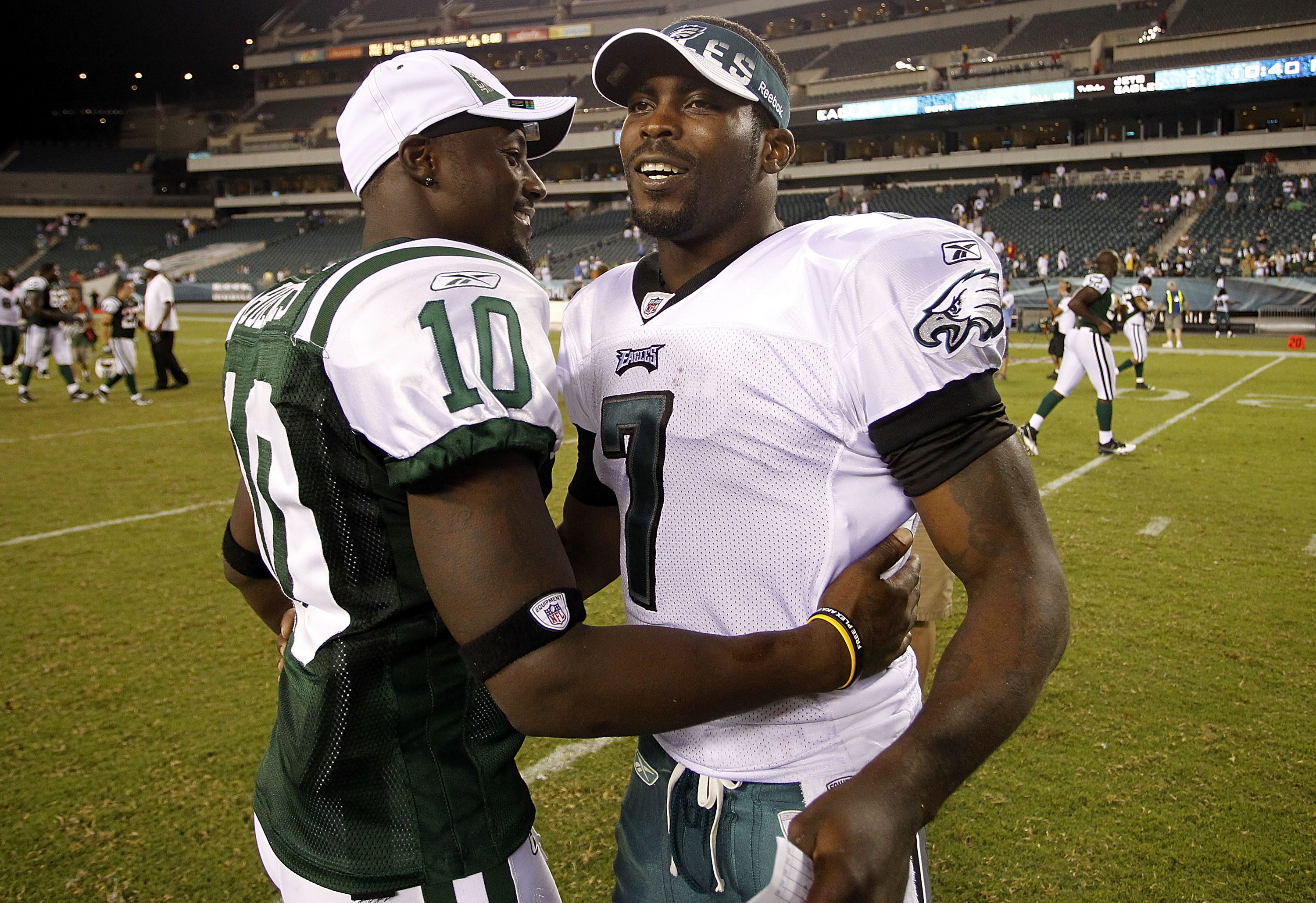 PHILADELPHIA - SEPTEMBER 02:  Michael Vick #7 of the Philadelphia Eagles hugs Santonio Holmes #10 of the New York Jets after a preseason game at Lincoln Financial Field on September 2, 2010 in Philadelphia, Pennsylvania.  (Photo by Jeff Zelevansky/Getty I