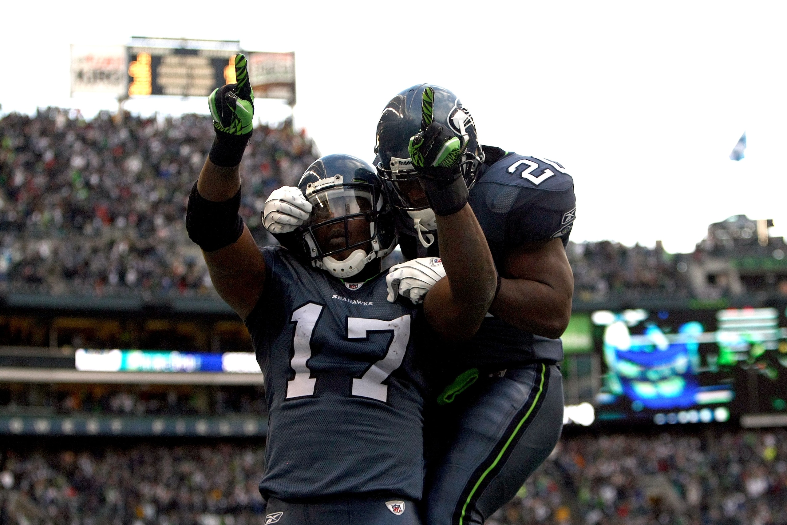 SEATTLE, WA - JANUARY 08:  Wide receiver Mike Williams #17 of the Seattle Seahawks reacts with teammate Justin Forsett #20 after catching a 38-yard third quarter touchdown pass against the New Orleans Saints during the 2011 NFC wild-card playoff game at Q
