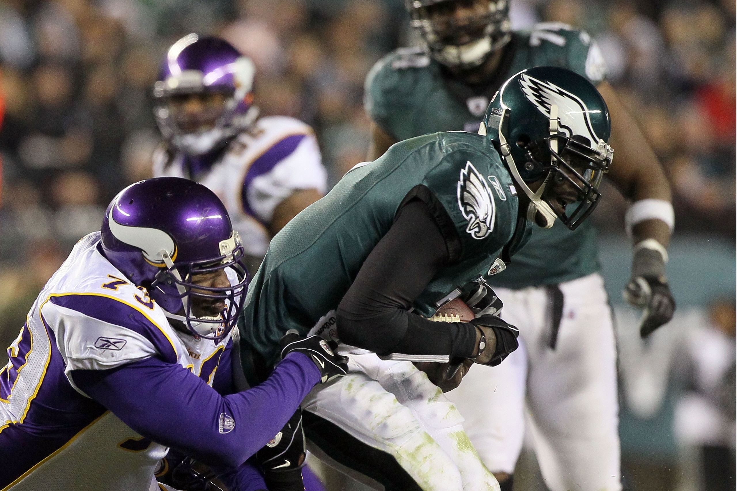 PHILADELPHIA, PA - DECEMBER 28:  Michael Vick #7 of the Philadelphia Eagles fumbles against Jimmy Kennedy #73 of the Minnesota Vikings at Lincoln Financial Field on December 26, 2010 in Philadelphia, Pennsylvania.  (Photo by Jim McIsaac/Getty Images)