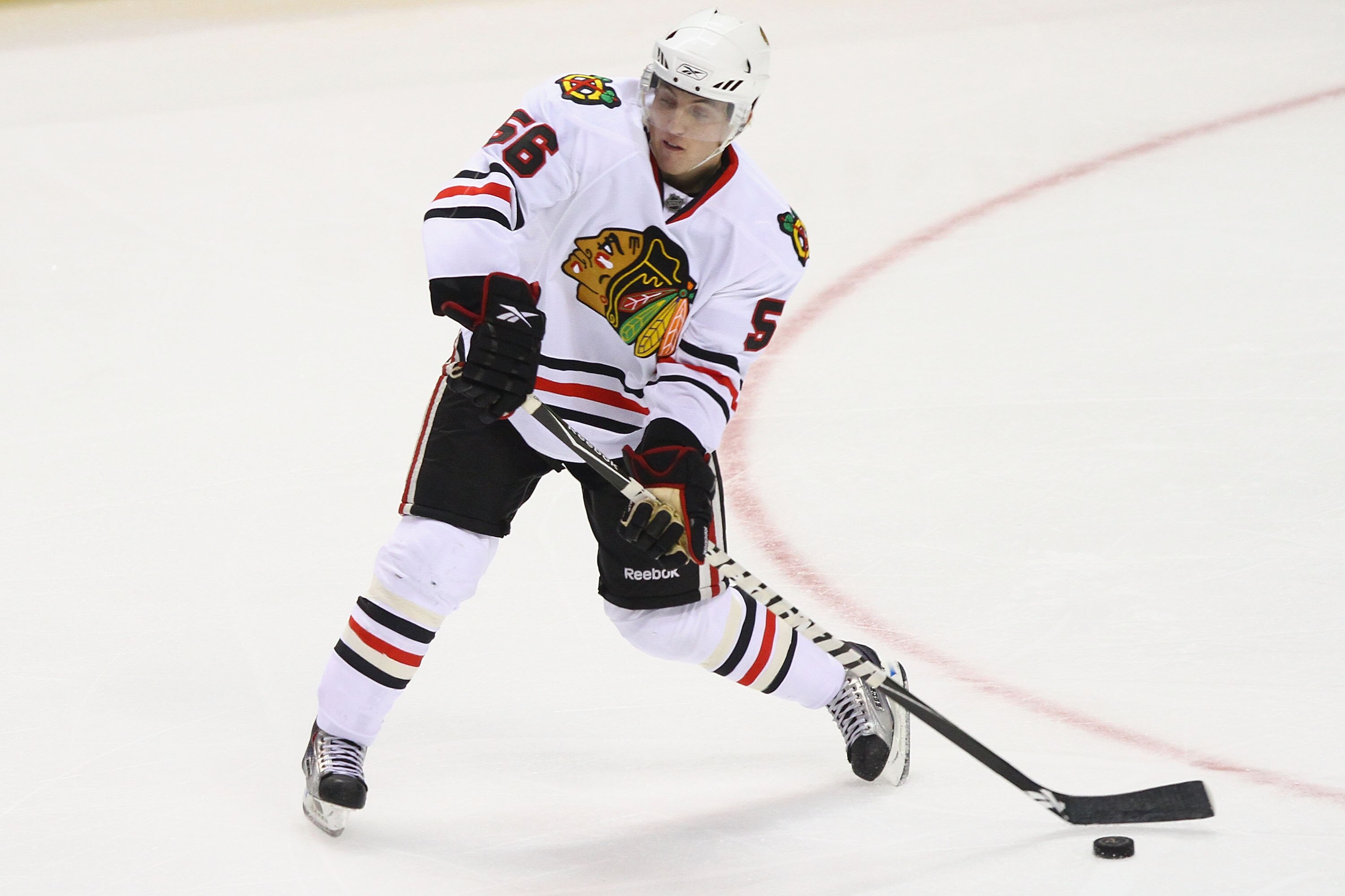 ST. LOUIS - SEPTEMBER 30: Brian Connelly #56 of the Chicago Blackhawks passes the puck against the St. Louis Blues during a pre-season game at the Scottrade Center on September 30, 2010 in St. Louis, Missouri.  (Photo by Dilip Vishwanat/Getty Images)