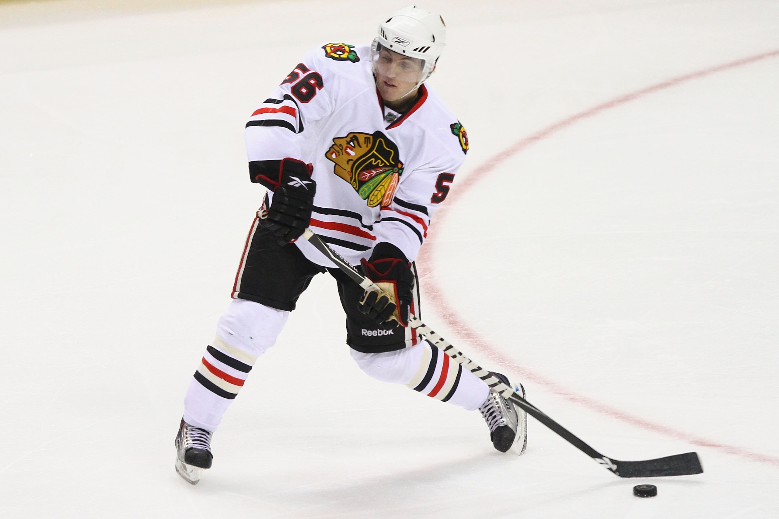 ST. LOUIS - SEPTEMBER 30: Brian Connelly #56 of the Chicago Blackhawks passes the puck against the St. Louis Blues during a pre-season game at the Scottrade Center on September 30, 2010 in St. Louis, Missouri.  (Photo by Dilip Vishwanat/Getty Images)