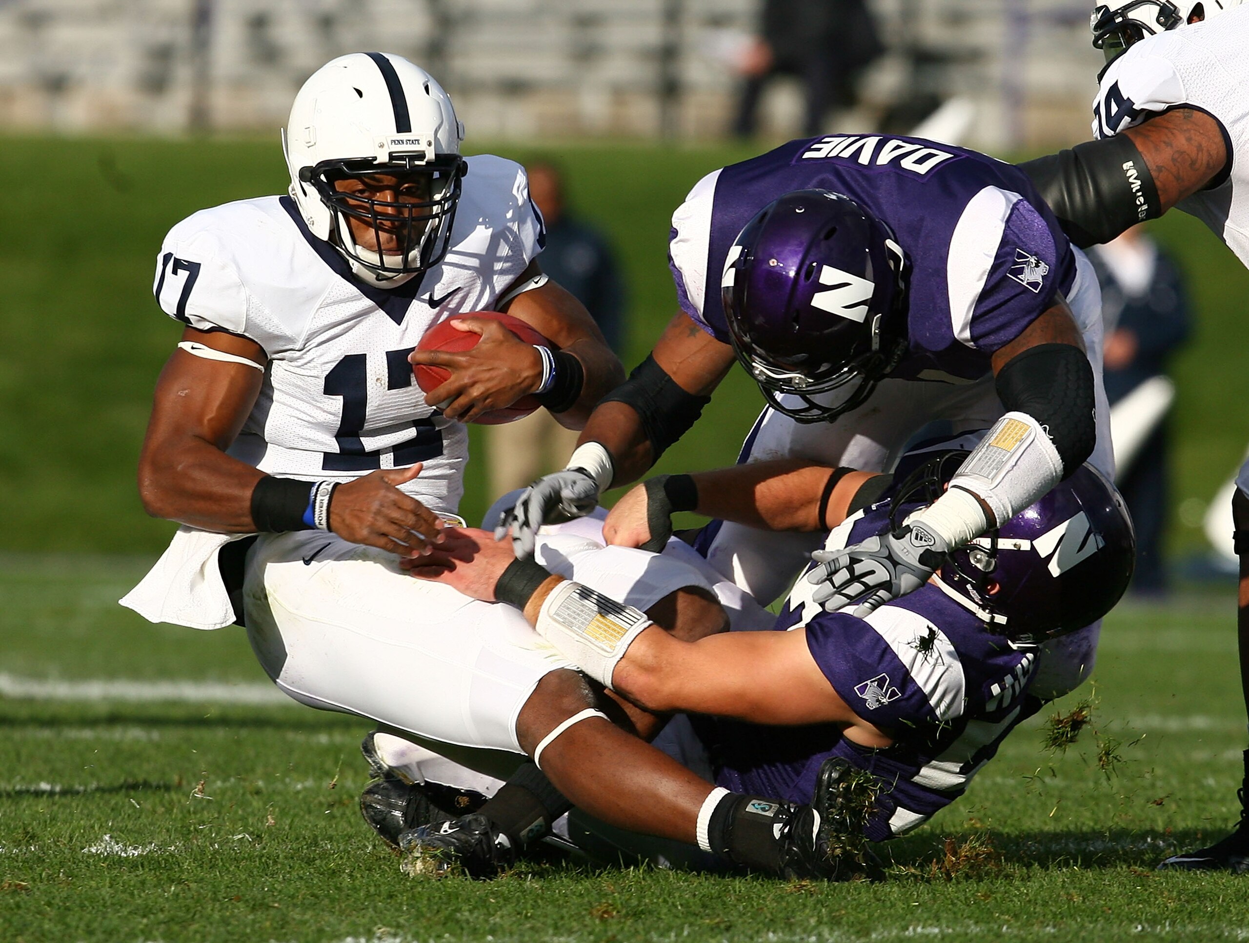 EVANSTON, IL - OCTOBER 31: Daryll Clark #17 of the Penn State Nittany Lions is tackled by Nate Williams #57 and Quentin Davie #41 of the Northwestern Wildcats at Ryan Field on October 31, 2009 in Evanston, Illinois. (Photo by Jonathan Daniel/Getty Images)