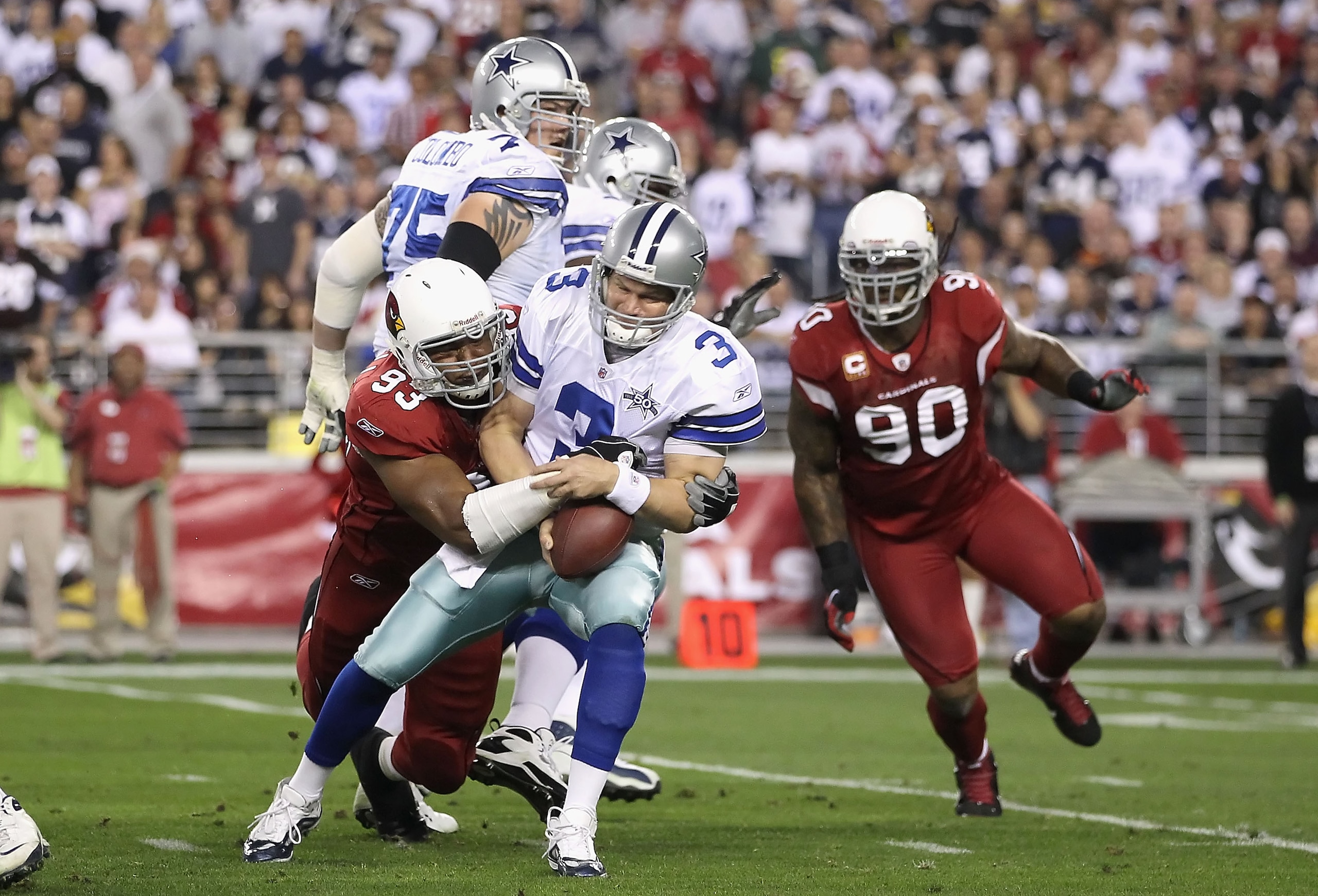 GLENDALE, AZ - DECEMBER 25: Quarterback Jon Kitna #3 of the Dallas Cowboys is sacked by Calais Campbell #93 of the Arizona Cardinals during the first quarter of the NFL game at the University of Phoenix Stadium on December 25, 2010 in Glendale, Arizona. GLENDALE, AZ - DECEMBER 25: Quarterback Jon Kitna #3 of the Dallas Cowboys is sacked by Calais Campbell #93 of the Arizona Cardinals during the first quarter of the NFL game at the University of Phoenix Stadium on December 25, 2010 in Glendale, Arizona.