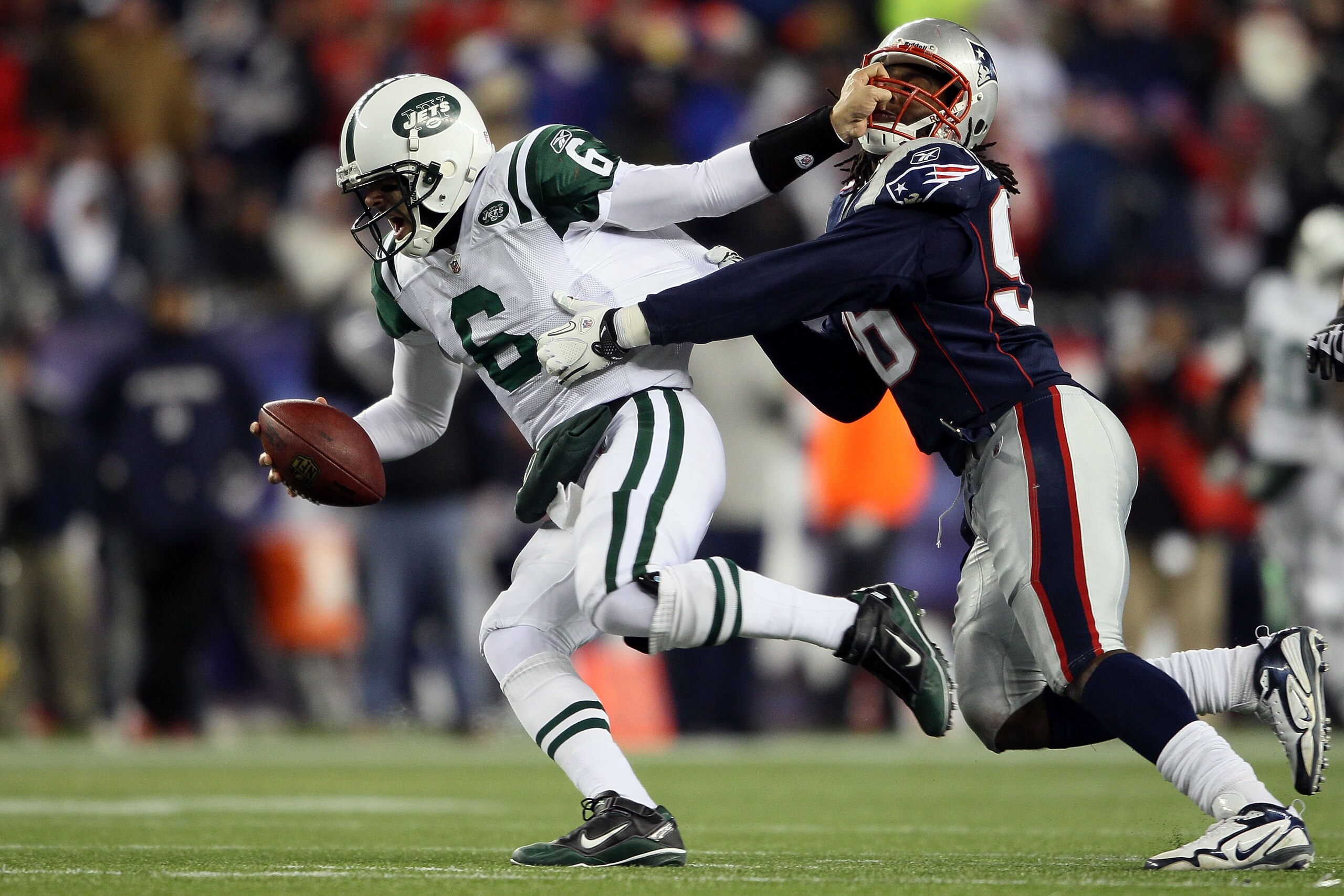 FOXBORO, MA - DECEMBER 06:  Mark Sanchez #6 of the New York Jets attempts to escape the pass rush of Jermaine Cunningham #96 of the New England Patriots at Gillette Stadium on December 6, 2010 in Foxboro, Massachusetts.  (Photo by Elsa/Getty Images)