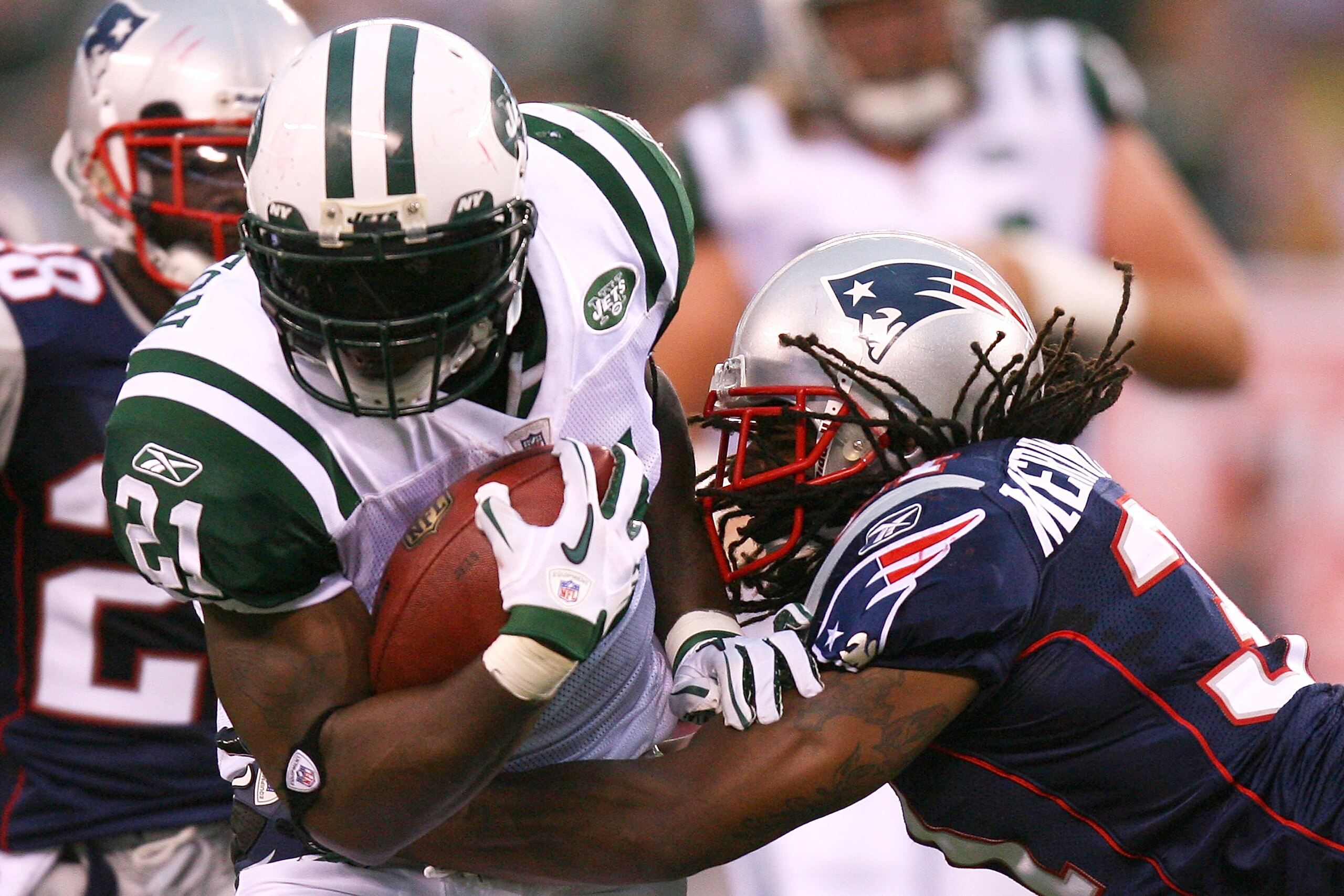 EAST RUTHERFORD, NJ - SEPTEMBER 19:  LaDainian Tomlinson #21 of the New York Jets is tackled by Brandon Meriweather #31 of the New England Patriots at the New Meadowlands Stadium on September 19, 2010 in East Rutherford, New Jersey. The Jets defeated the