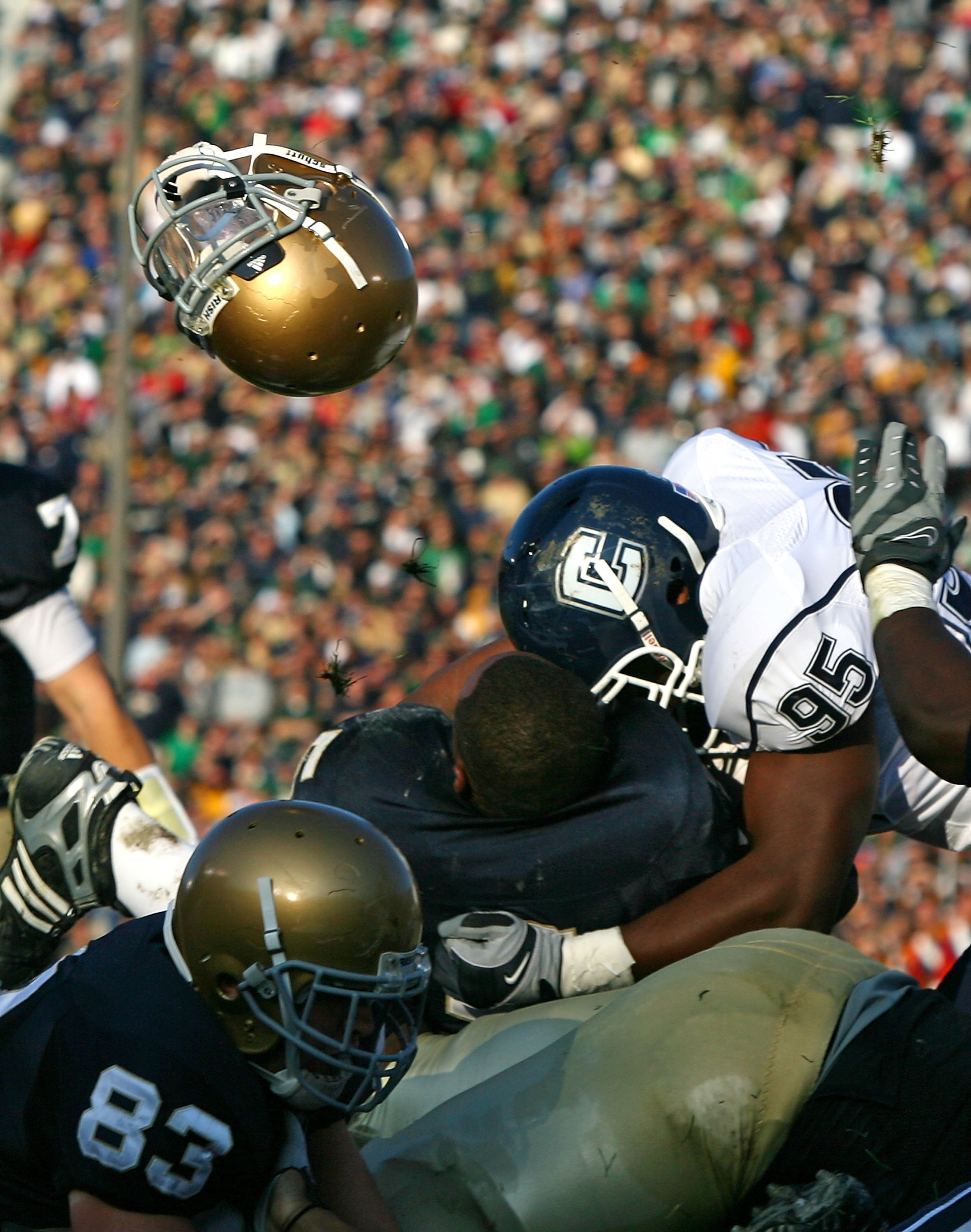 SOUTH BEND, IN - NOVEMBER 21: Armando Allen #5 of the Notre Dame Fighting Irish looses his helmut as he is hit at the goalline by Greg Lloyd #95 of the Univeristy of Connecticut Huskies at Notre Dame Stadium on November 21, 2009 in South Bend, Indiana. (P SOUTH BEND, IN - NOVEMBER 21: Armando Allen #5 of the Notre Dame Fighting Irish looses his helmut as he is hit at the goalline by Greg Lloyd #95 of the Univeristy of Connecticut Huskies at Notre Dame Stadium on November 21, 2009 in South Bend, Indiana. (P