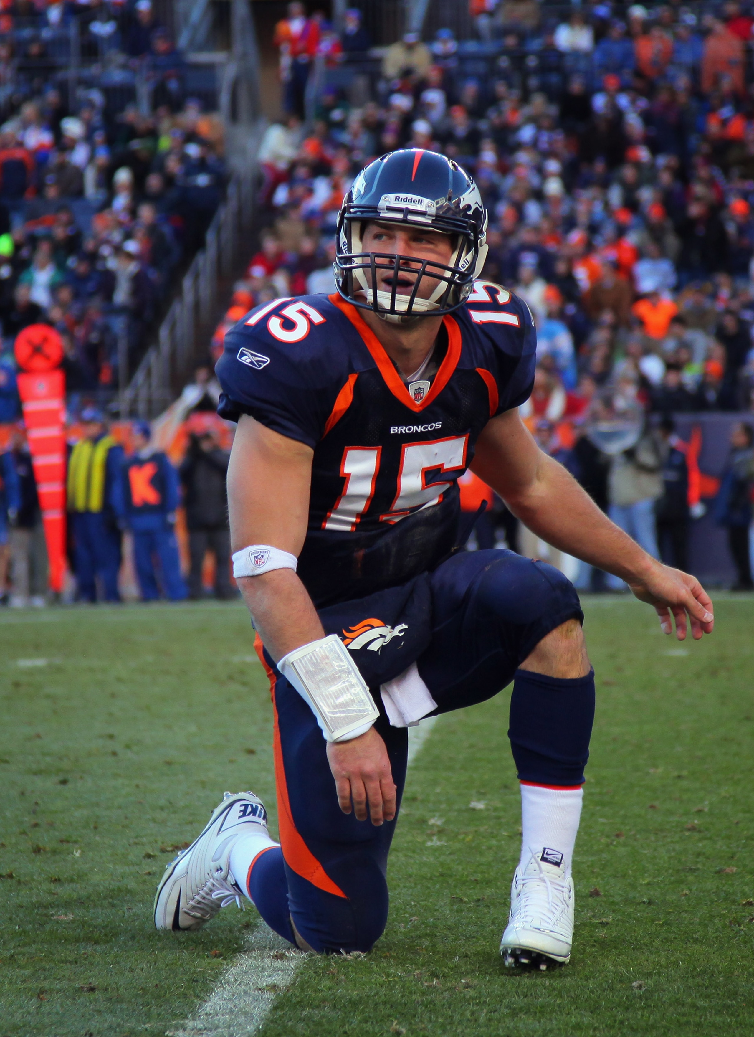 DENVER - JANUARY 02:  Quarterback Tim Tebow #15 of the Denver Broncos gets back on his feet after being knocked down against the San Diego Chargers at INVESCO Field at Mile High on January 2, 2011 in Denver, Colorado.  (Photo by Doug Pensinger/Getty Image