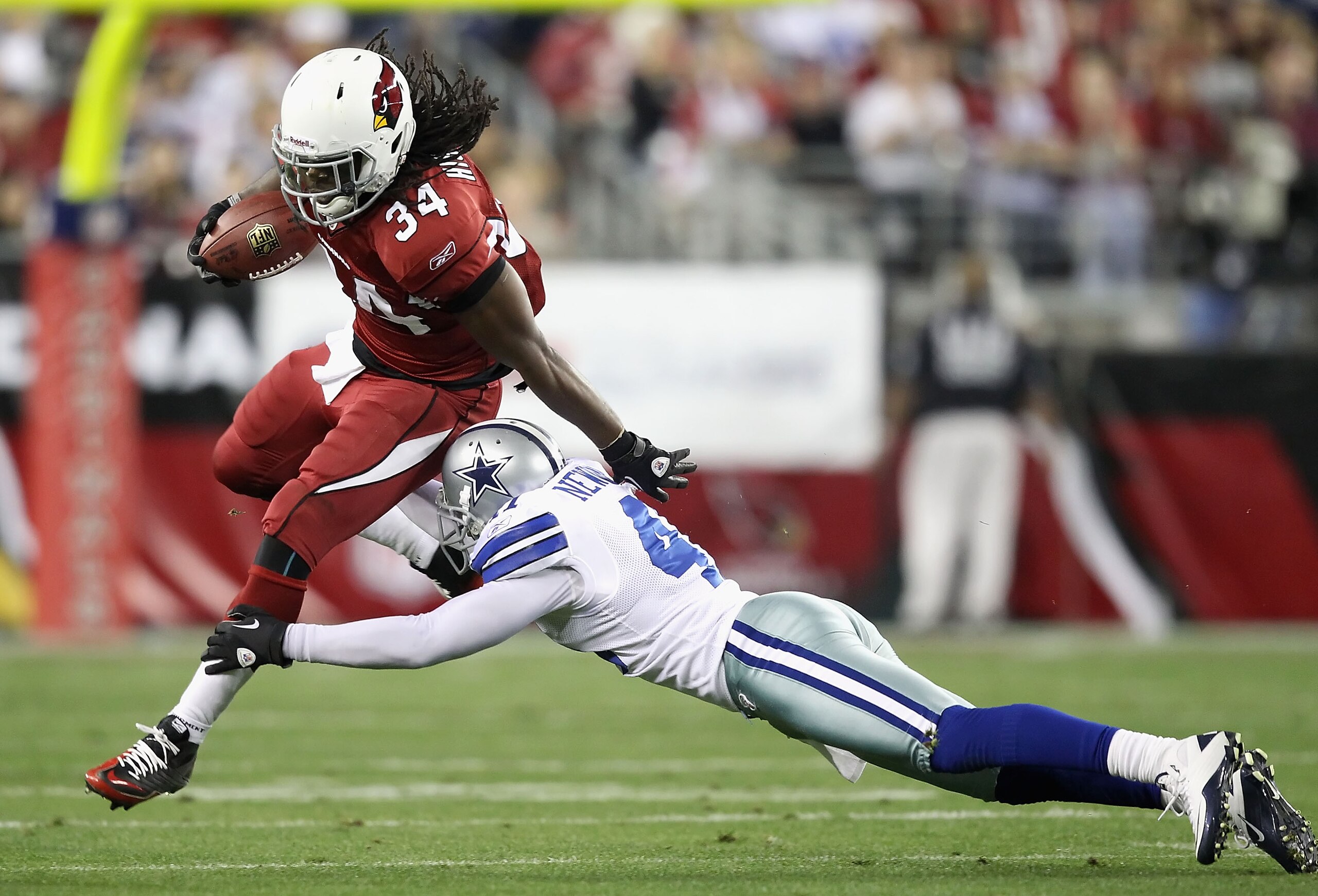 GLENDALE, AZ - DECEMBER 25:   Runningback Tim Hightower #34 of the Arizona Cardinals leaps past Terence Newman #41 of the Dallas Cowboys during the NFL game at the University of Phoenix Stadium on December 25, 2010 in Glendale, Arizona.  The Cardinals def