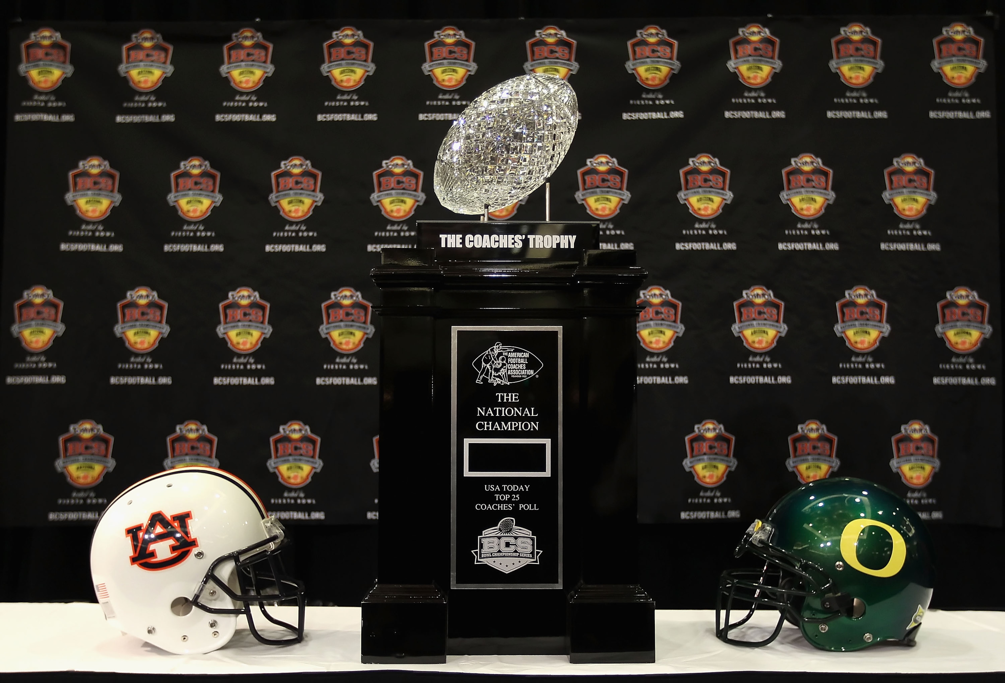SCOTTSDALE, AZ - JANUARY 07: The coaches trophy is displayed with helmets for the Auburn Tigers and the Oregon Ducks during Media Day for the Tostitos BCS National Championship Game at the JW Marriott Camelback Inn on January 7, 2011 in Scottsdale, Arizo SCOTTSDALE, AZ - JANUARY 07: The coaches trophy is displayed with helmets for the Auburn Tigers and the Oregon Ducks during Media Day for the Tostitos BCS National Championship Game at the JW Marriott Camelback Inn on January 7, 2011 in Scottsdale, Arizo