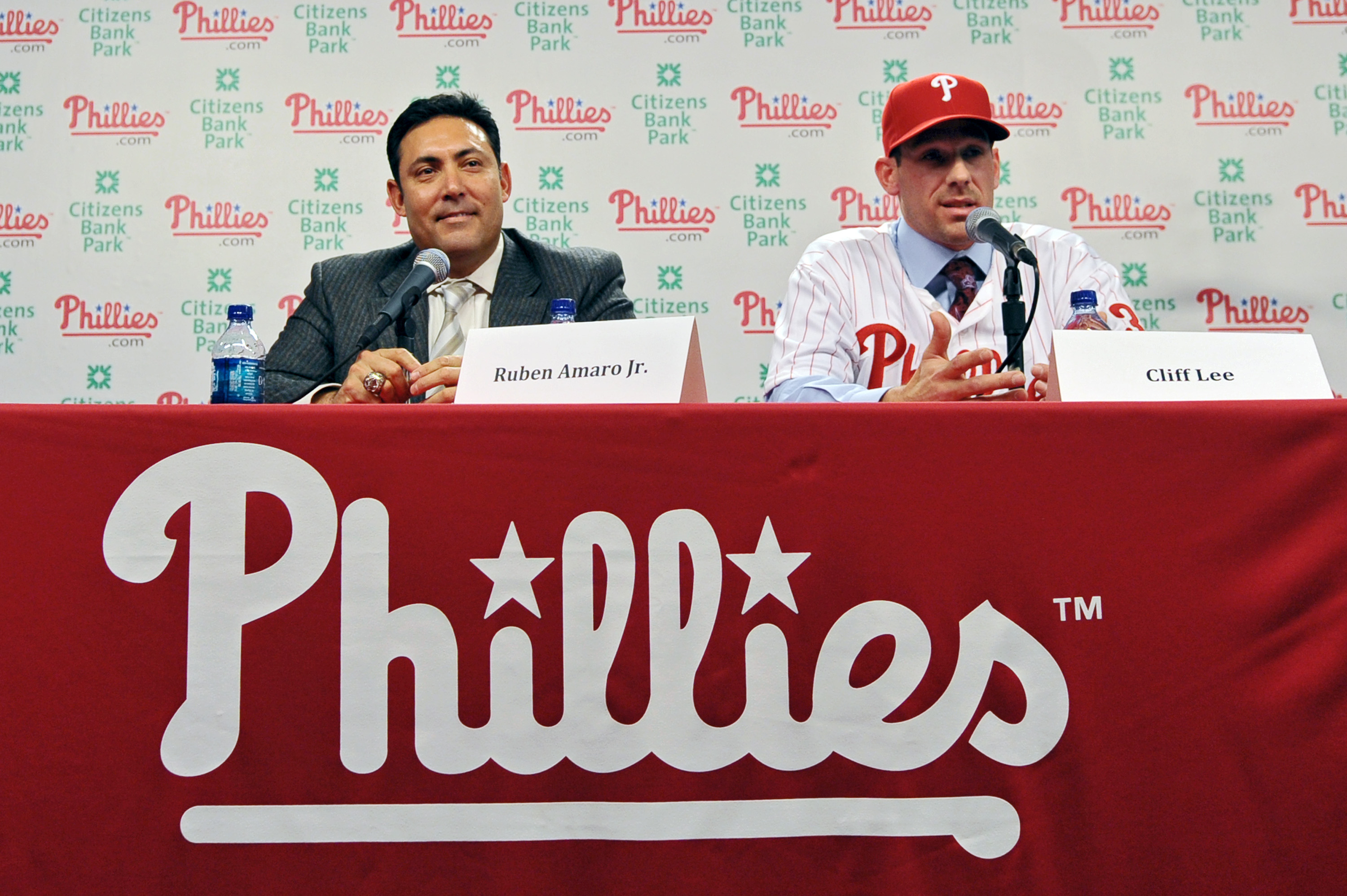 PHILADELPHIA - DECEMBER 15: Pitcher Cliff Lee #33 of the Philadelphia Phillies talks with the media while general manager Ruben Amaro Jr. watches during a press conference at Citizens Bank Park on December 15, 2010 in Philadelphia, Pennsylvania. (Photo by