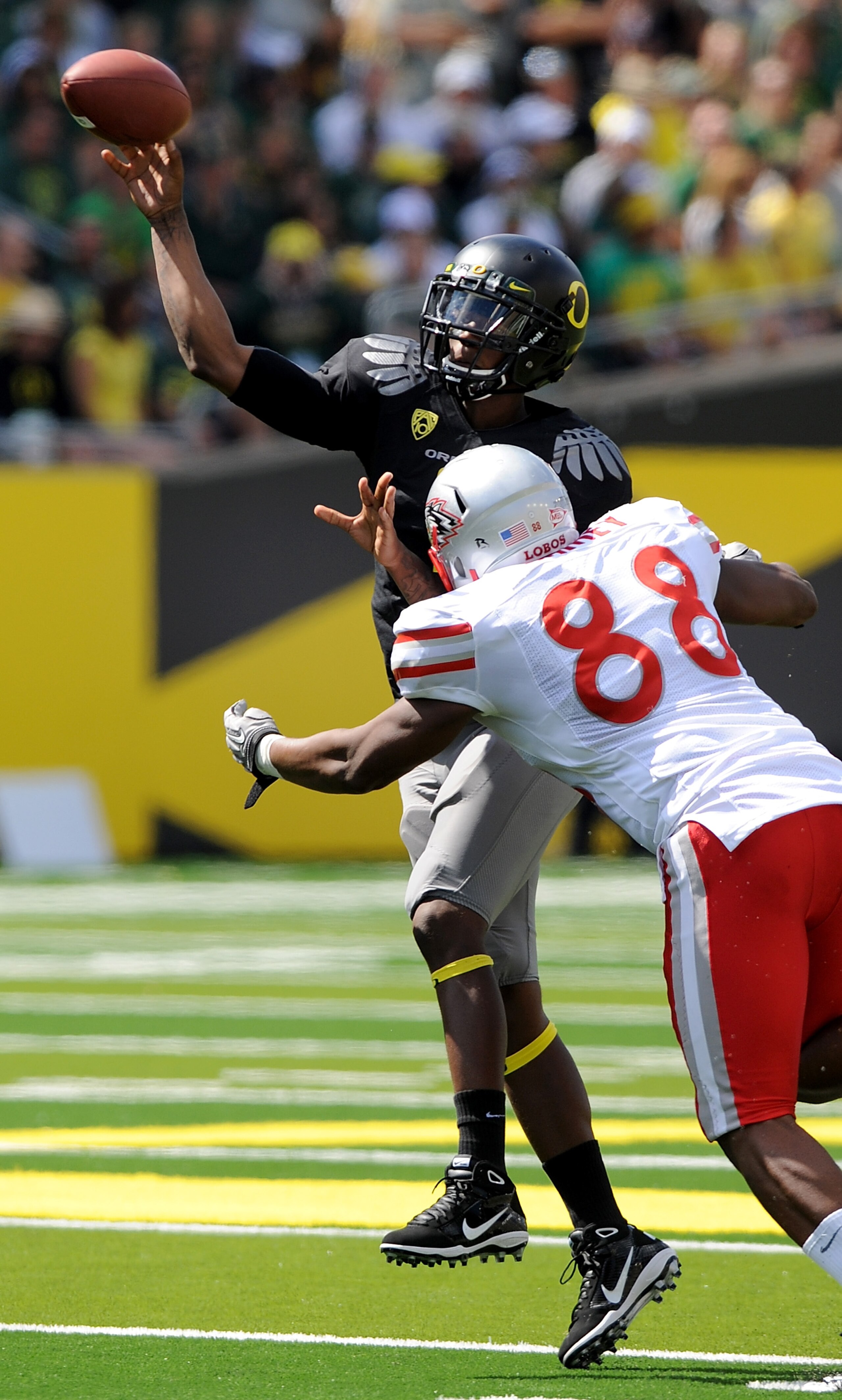 EUGENE, OR - SEPTEMBER 04: Quarterback Darron Thomas #1 of the Oregon Ducks throws a pass as he is pressured by defensive end Johnathan Rainey #88 of the New Mexico Lobos in the first quarter of the game at Autzen Stadium on September 4, 2010 in Eugene, EUGENE, OR - SEPTEMBER 04: Quarterback Darron Thomas #1 of the Oregon Ducks throws a pass as he is pressured by defensive end Johnathan Rainey #88 of the New Mexico Lobos in the first quarter of the game at Autzen Stadium on September 4, 2010 in Eugene,