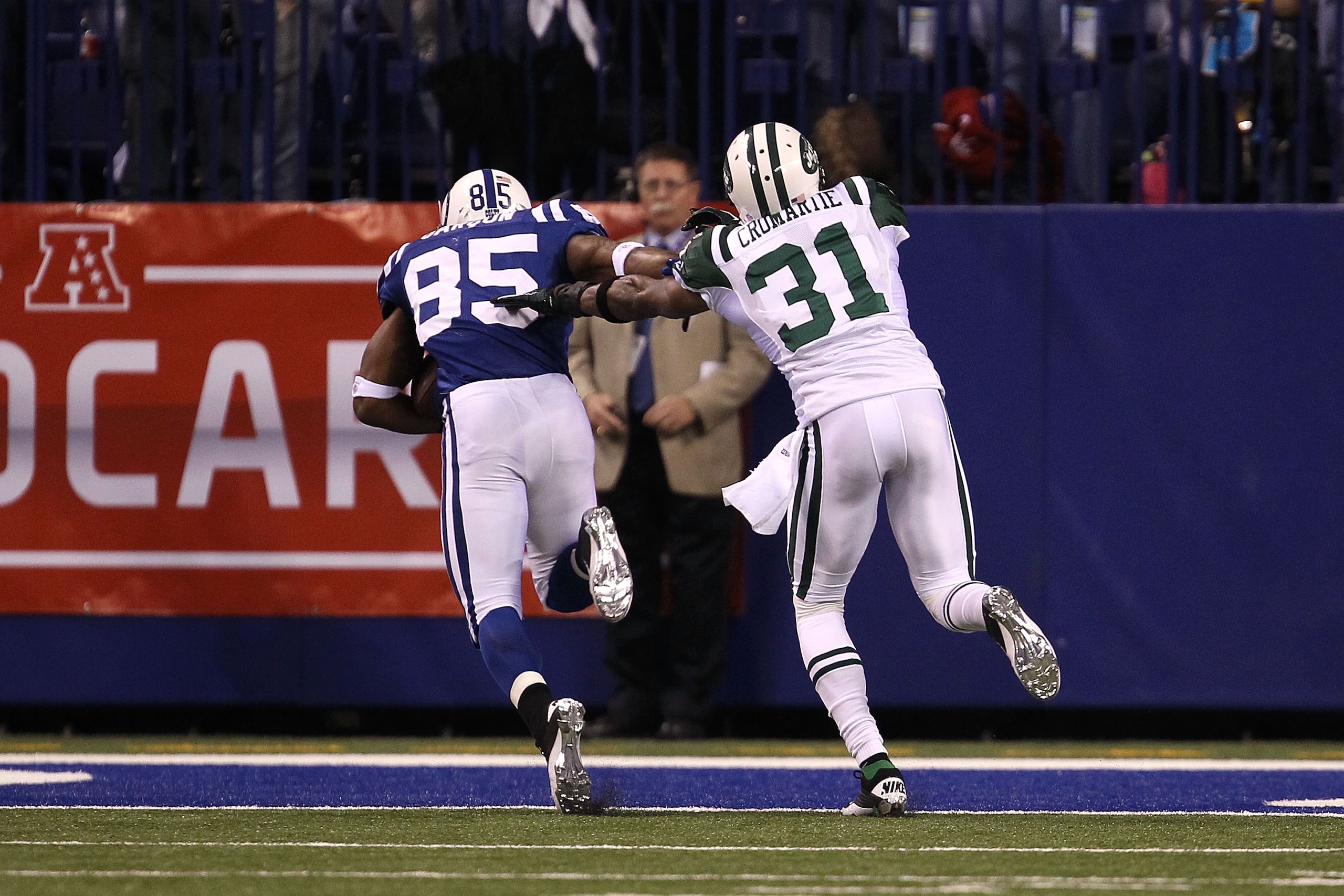 INDIANAPOLIS, IN - JANUARY 08:  Pierre Garcon #85 of the Indianapolis Colts scores on a 57-yard touchdown reception in the second quarter against Antonio Cromartie #31 of the New York Jets during their 2011 AFC wild card playoff game at Lucas Oil Stadium