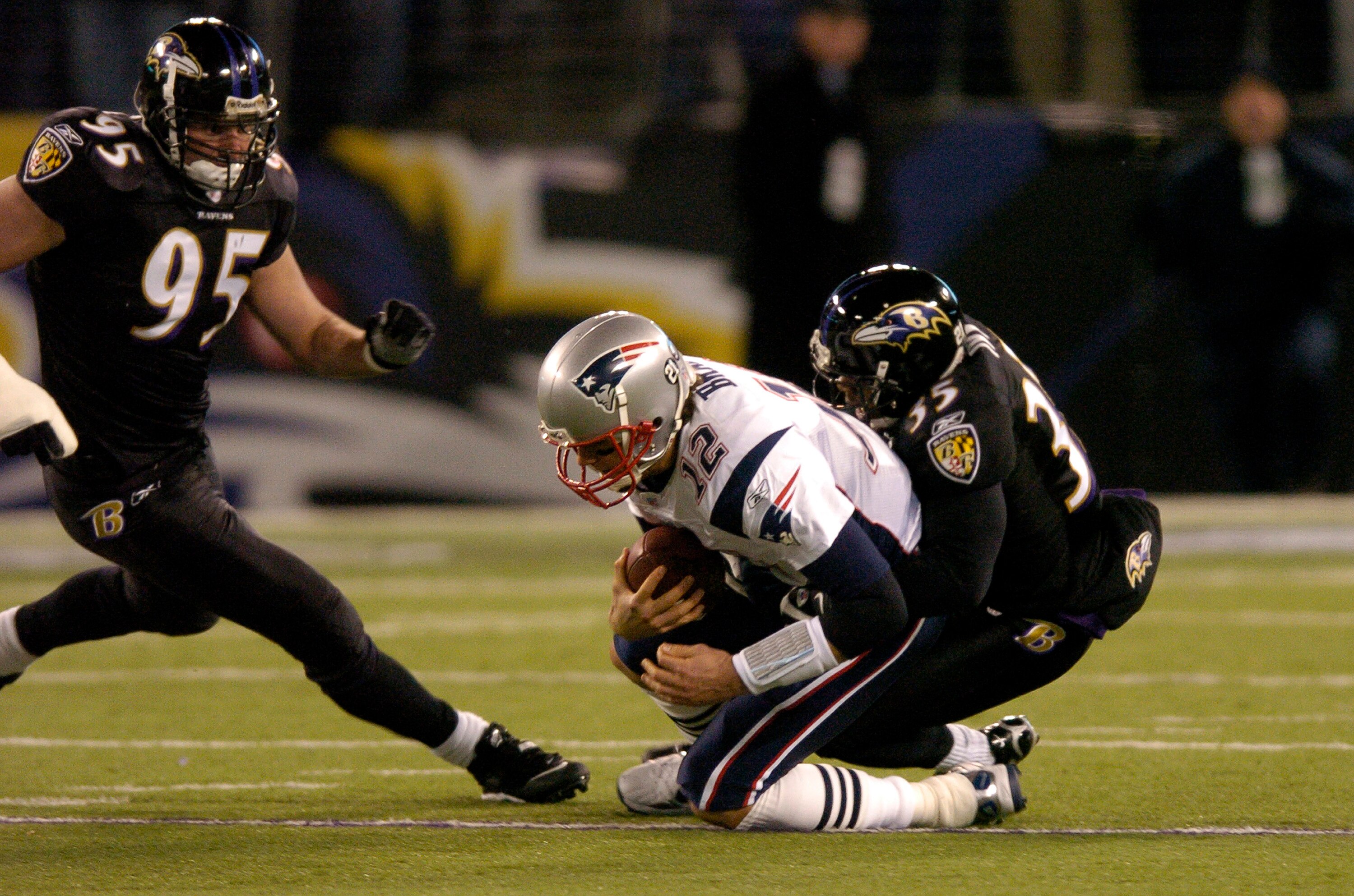 BALTIMORE - DECEMBER 3:  Tom Brady #12 of the New England Patriots is sacked by Corey Ivy #35 of the Baltimore Ravens at M&T Bank Stadium December 3, 2007 in Baltimore, Maryland.  (Photo by Greg Fiume/Getty Images)