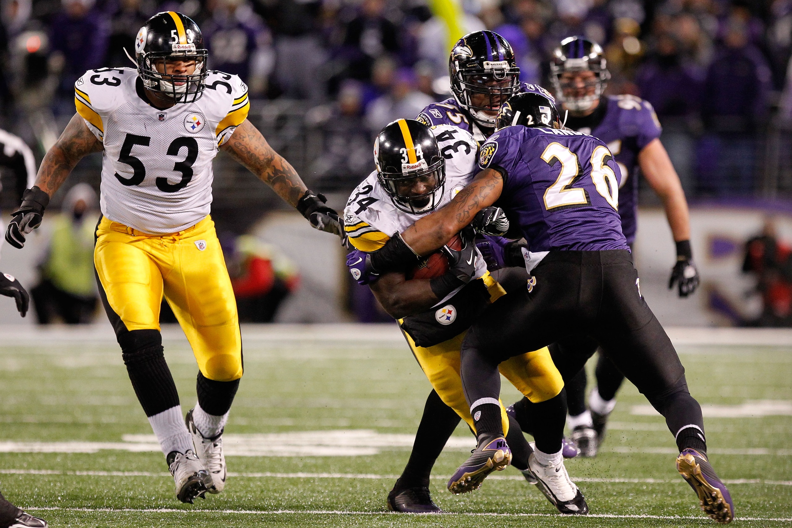 BALTIMORE, MD - DECEMBER 05:  Rashard Mendenhall #34  of the Pittsburgh Steelers runs the ball as he is tackled by Dawan Landry #26 of the Baltimore Ravens during the third quarter of the game at M&T Bank Stadium on December 5, 2010 in Baltimore, Maryland