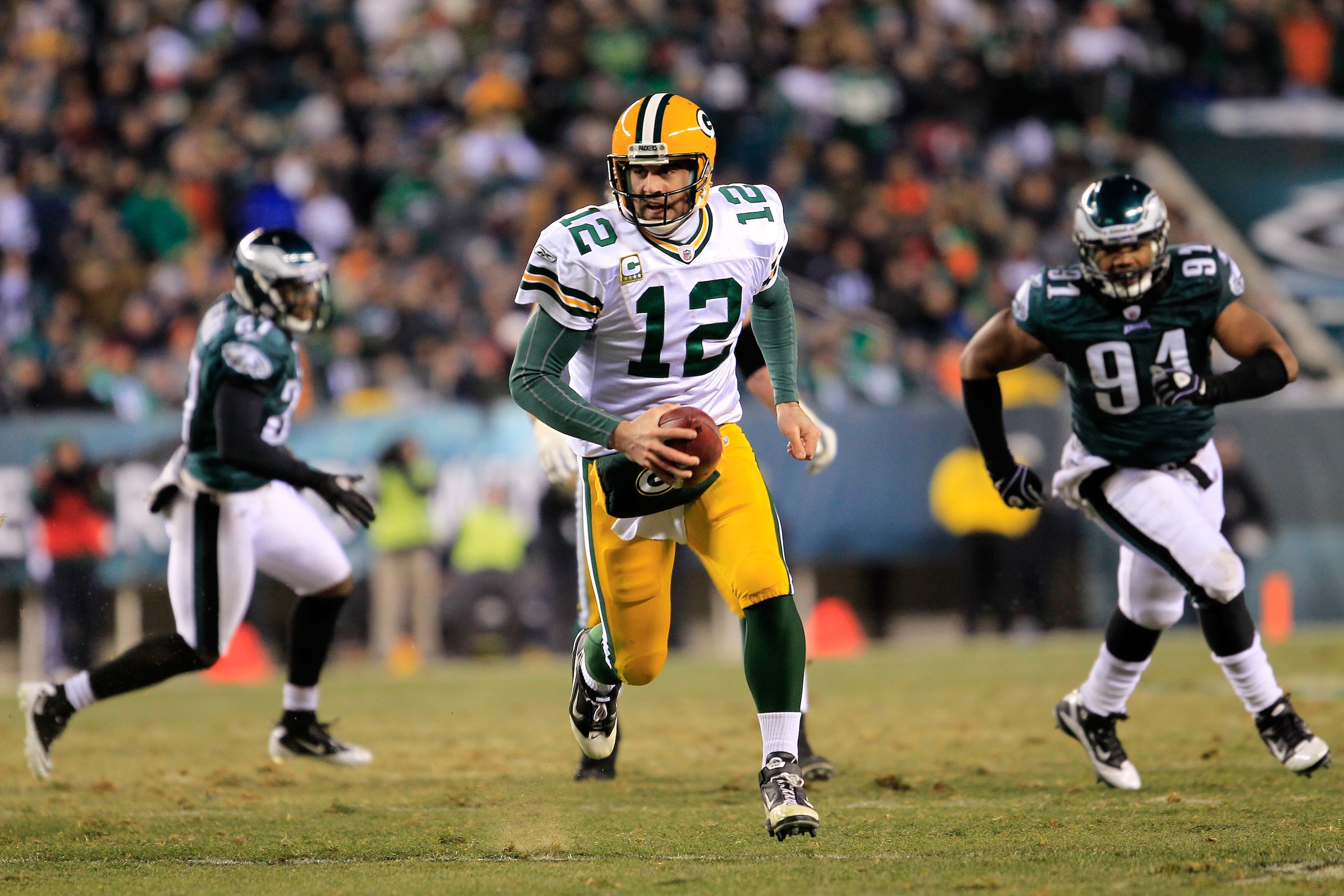 PHILADELPHIA, PA - JANUARY 09:  Aaron Rodgers #12 of the Green Bay Packers carries the ball against the Philadelphia Eagles during the 2011 NFC wild card playoff game at Lincoln Financial Field on January 9, 2011 in Philadelphia, Pennsylvania.  (Photo by 