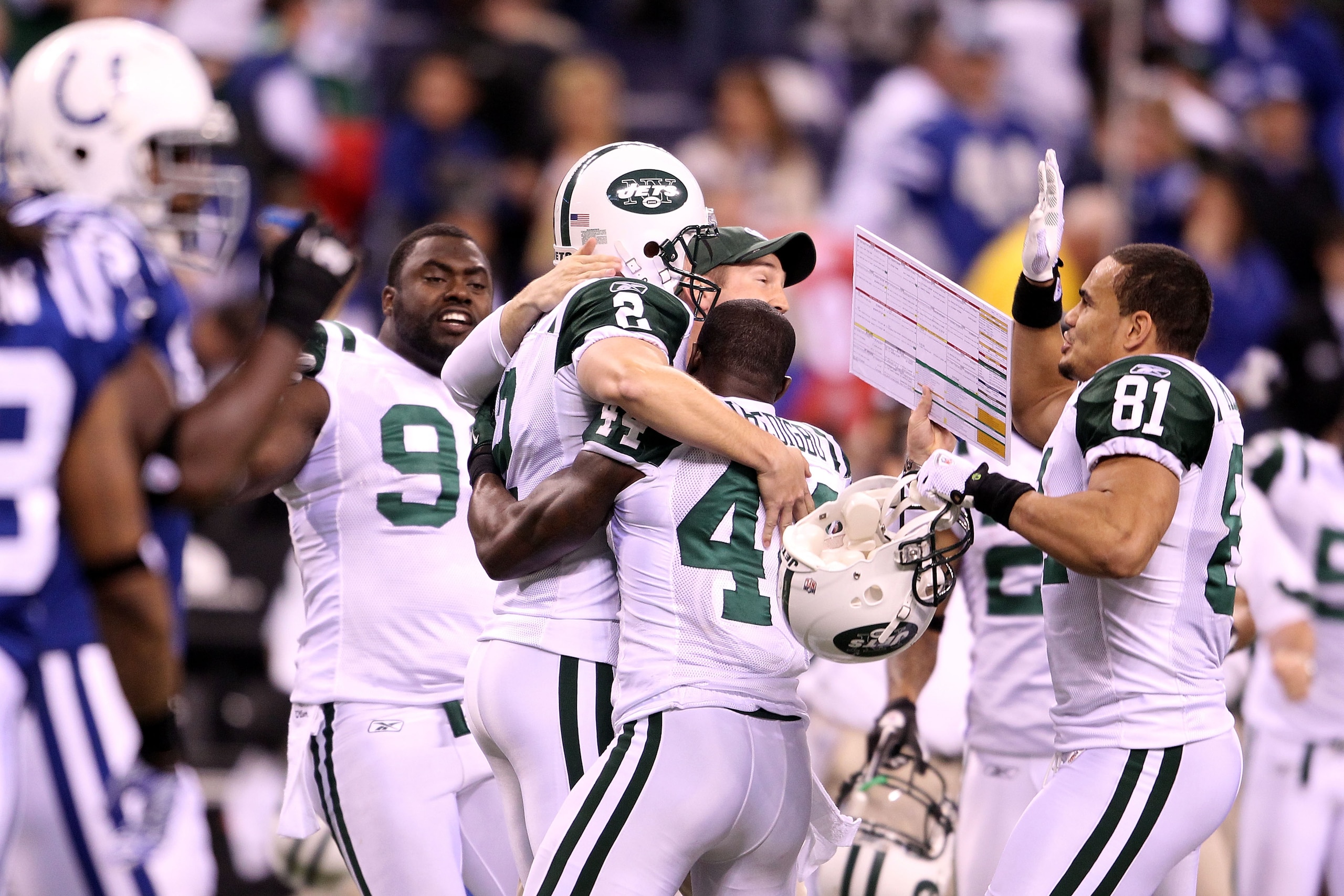 INDIANAPOLIS, IN - JANUARY 08:  Place kicker Nick Folk #2 of the New York Jets celebrates with Shaun Ellis #92, James Ihedigbo #44 and Dustin Keller #81 after Folk successfully kicked a game-winning a 32-yard field goal in the fourth quarter to win 17-16