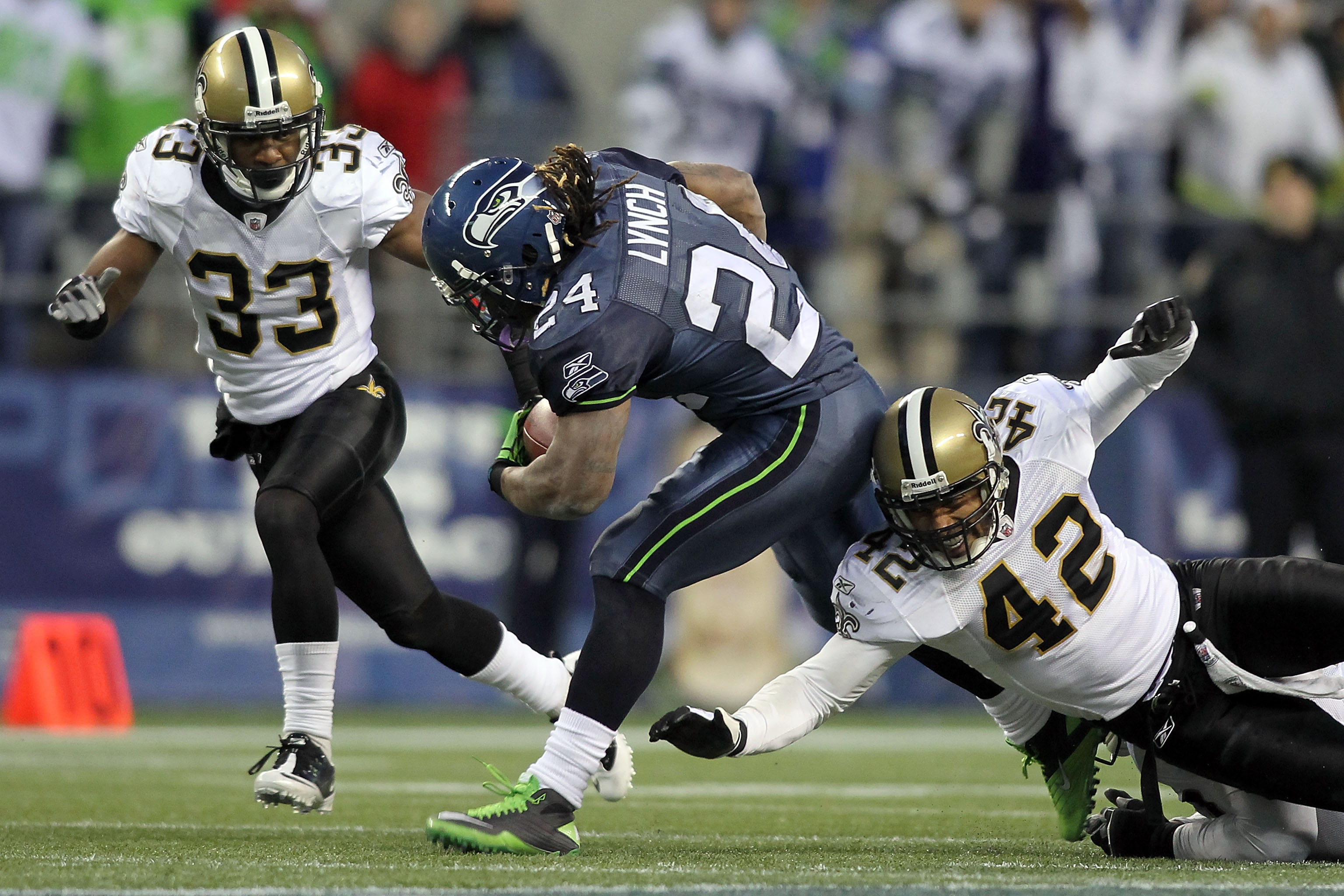 SEATTLE, WA - JANUARY 08:  Running back Marshawn Lynch #24 of the Seattle Seahawks runs for a 67-yard touchdown run in the fourth quarter as Darren Sharper #42 of the New Orleans Saints misses a tackle during the 2011 NFC wild-card playoff game at Qwest F