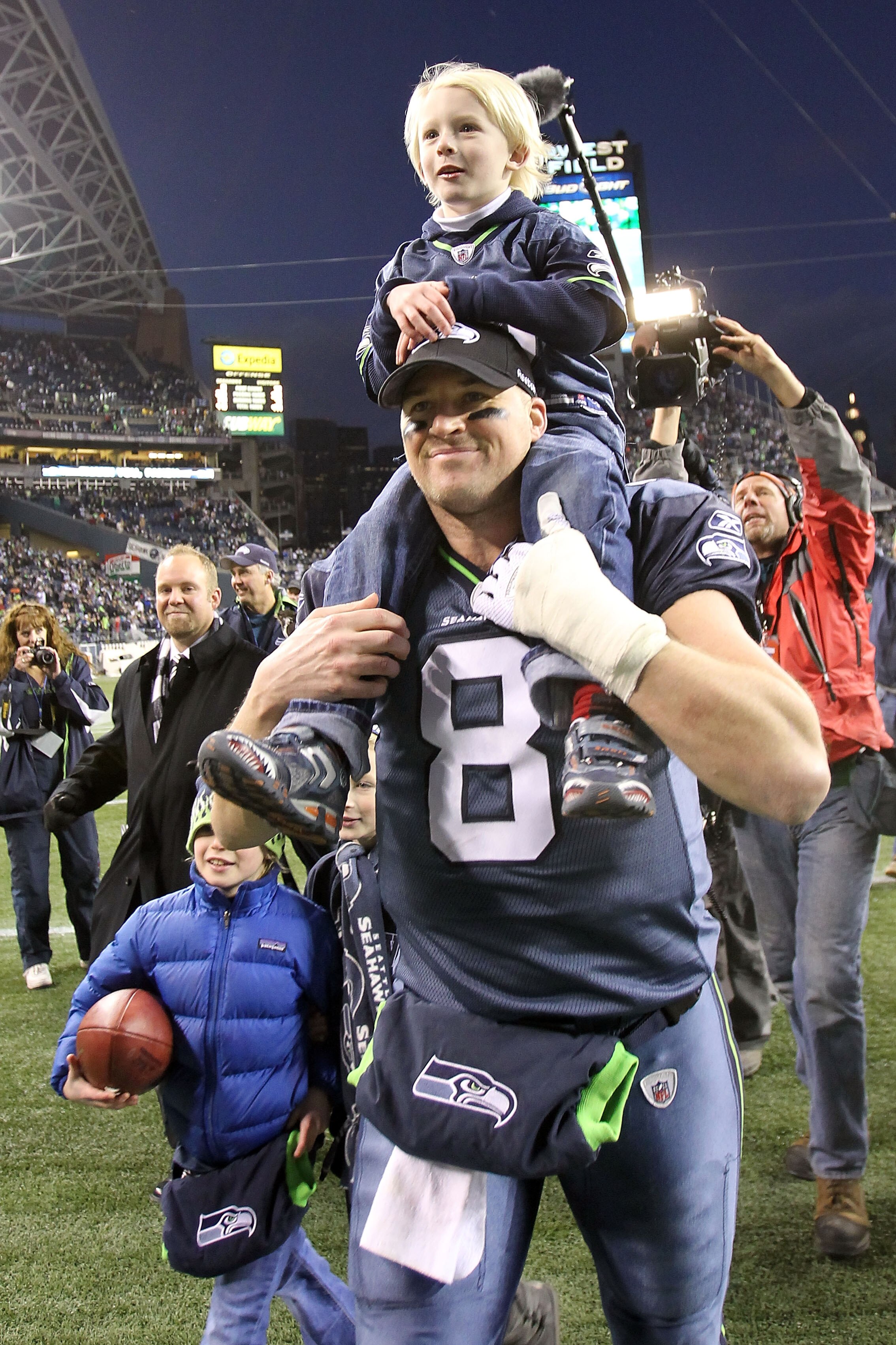 SEATTLE, WA - JANUARY 08:  Quarterback Matt Hasselbeck #8 of the Seattle Seahawks celebrates the Seahawks 41-36 victory against the New Orleans Saints as his son Henry Hasselbeck is carried off on his back after the 2011 NFC wild-card playoff game at Qwes