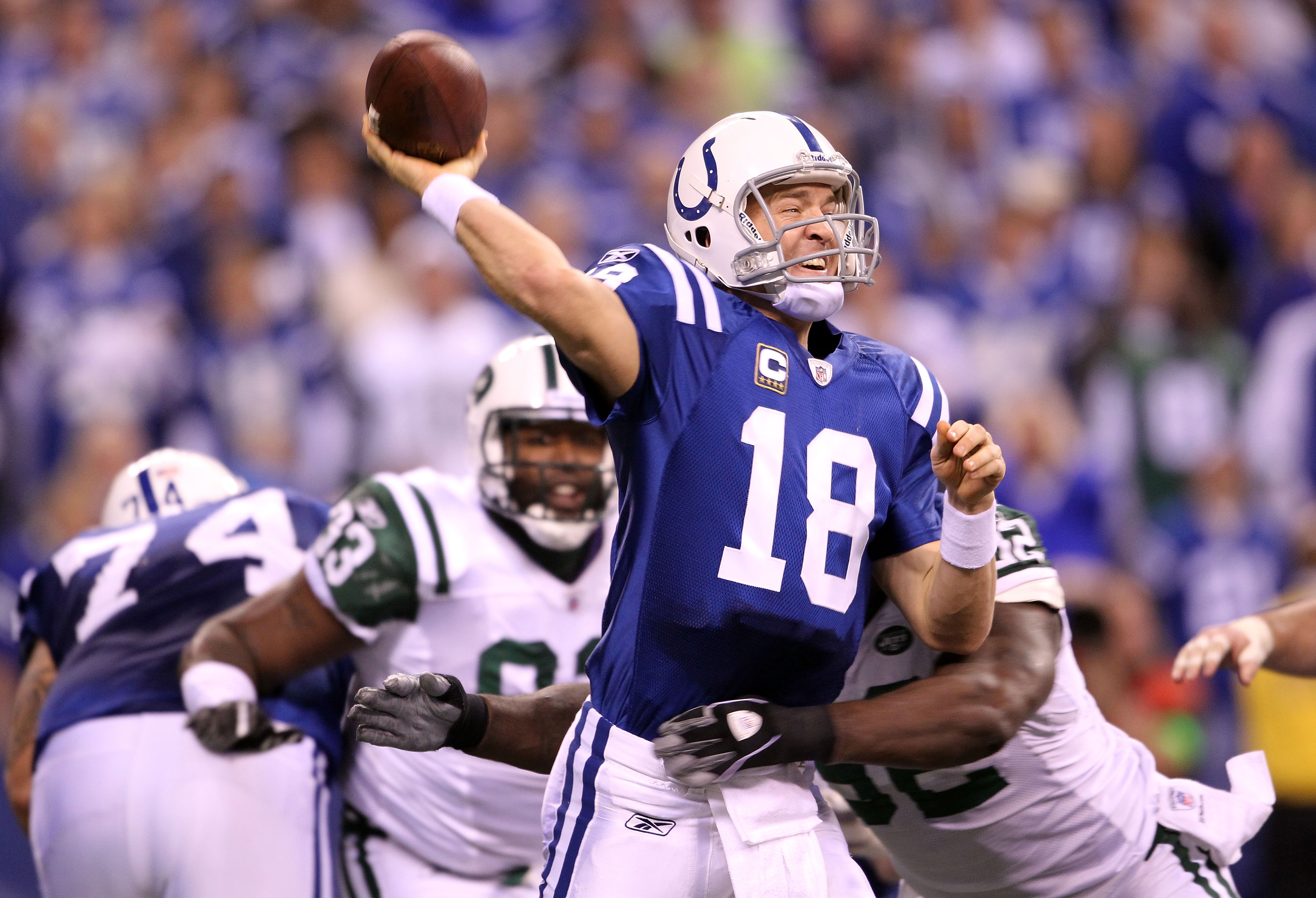 INDIANAPOLIS, IN - JANUARY 08:  Quarterback Peyton Manning #18 of the Indianapolis Colts throws a pss under pressure against the New York Jets during their 2011 AFC wild card playoff game at Lucas Oil Stadium on January 8, 2011 in Indianapolis, Indiana. T