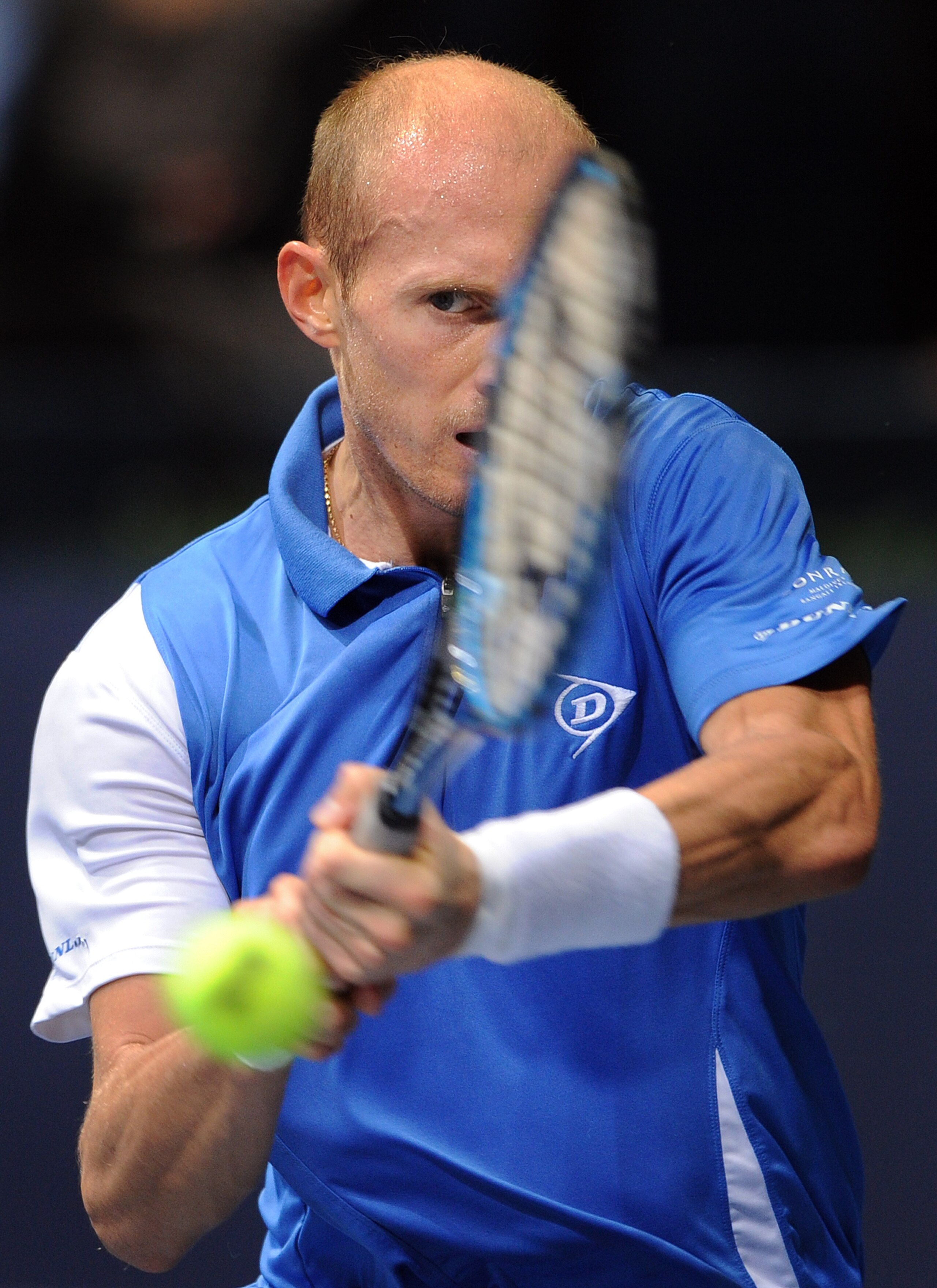VALENCIA, SPAIN - NOVEMBER 05:  Nikolay Davydenko of Russia plays a double handed backhand to Gilles Simon of France in his quarter final match during the ATP 500 World Tour Valencia Open tennis tournament at the Ciudad de las Artes y las Ciencias on Nove