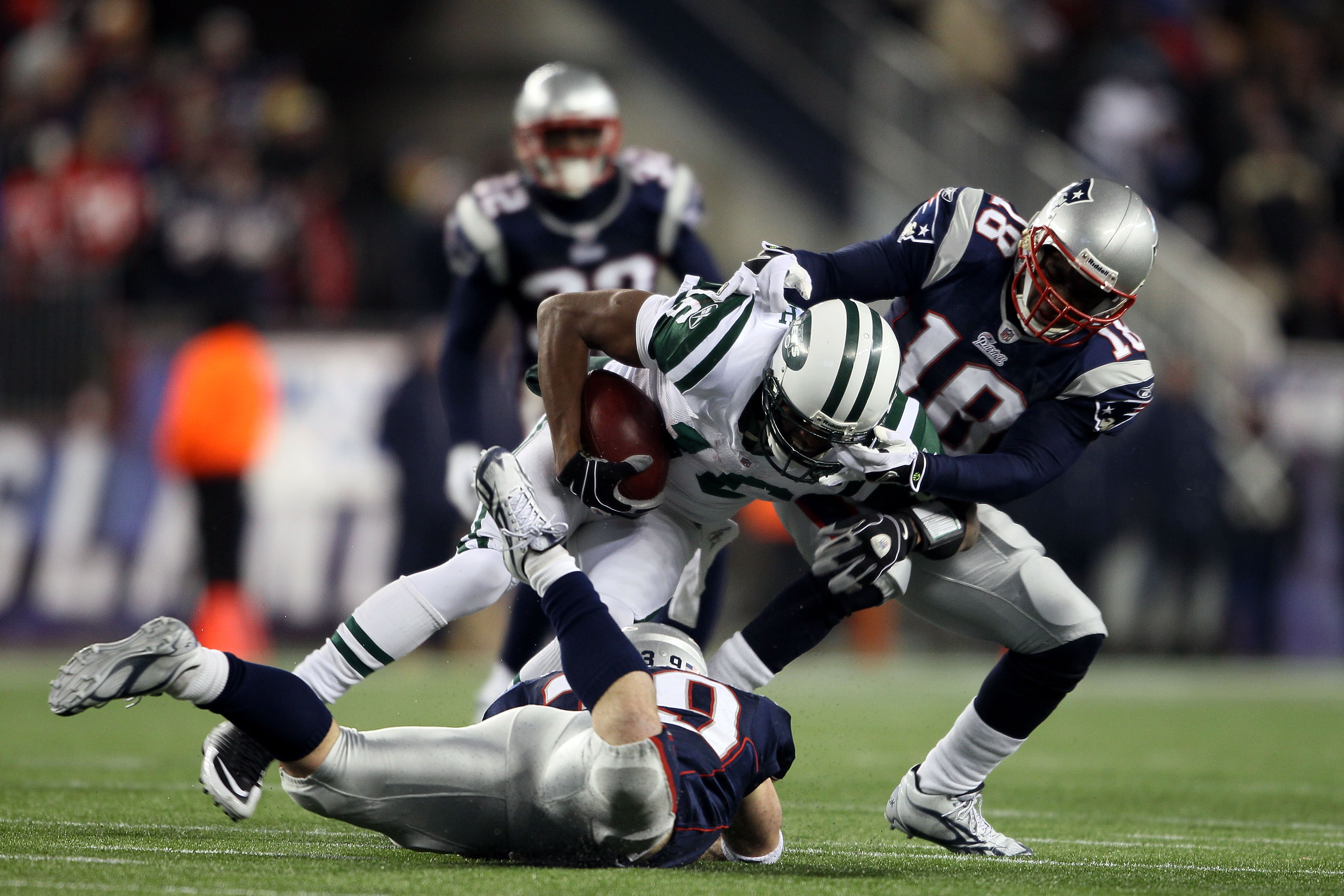 FOXBORO, MA - DECEMBER 06:  Brad Smith #16 of the New York Jets is tackled by Danny Woodhead #39 and Matthew Slater #18 of the New England Patriots at Gillette Stadium on December 6, 2010 in Foxboro, Massachusetts.  (Photo by Elsa/Getty Images)
